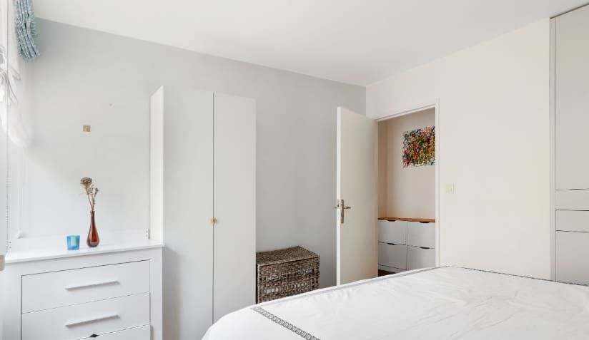 A bright and inviting bedroom featuring two comfortable single beds.