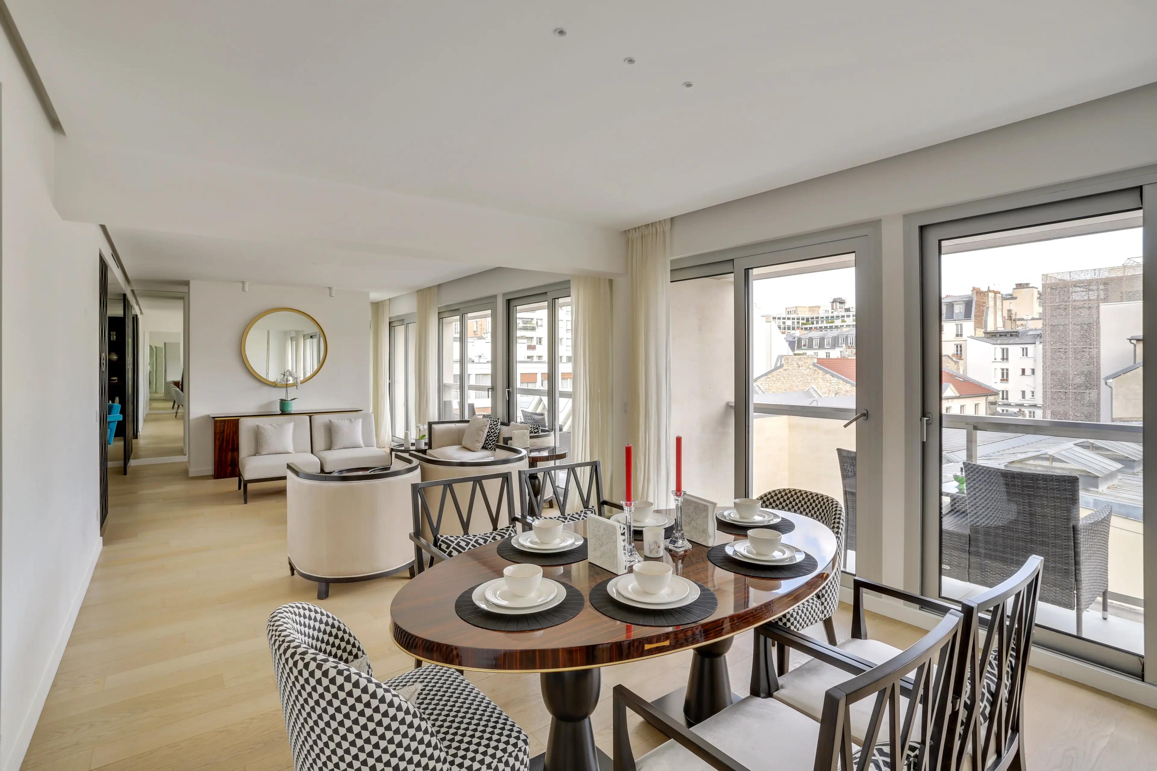 Renovated 4-bedroom duplex apartment for rent in Paris 7th arrondissement, bright living room with wraparound balcony and Paris rooftop view