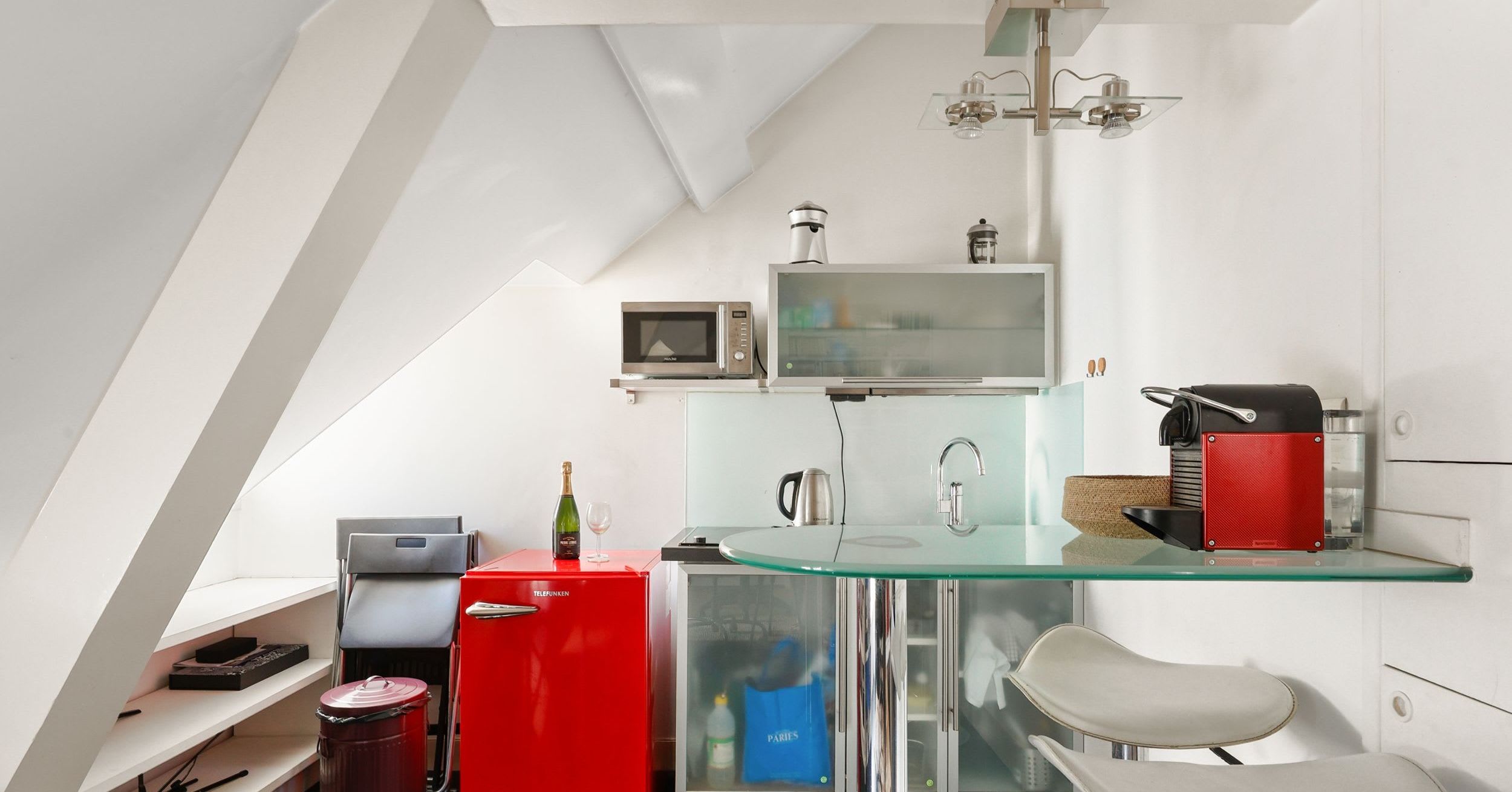 Charming furnished one-bedroom apartment rue Daguerre Paris 14th, bright top-floor living room with skylight windows and open kitchen