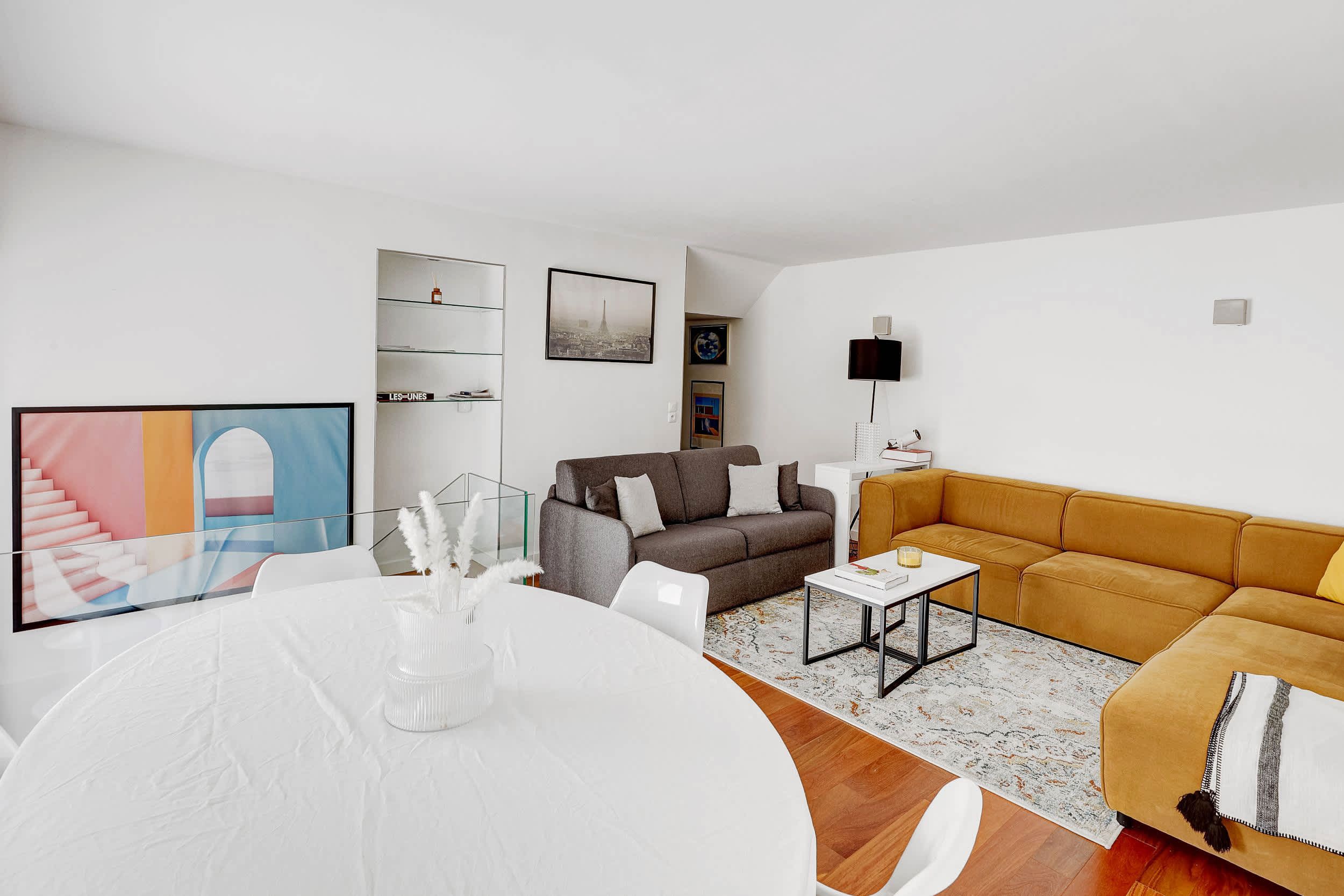 Welcoming and bright living room with a large corner sofa and a dining area with table and chairs.