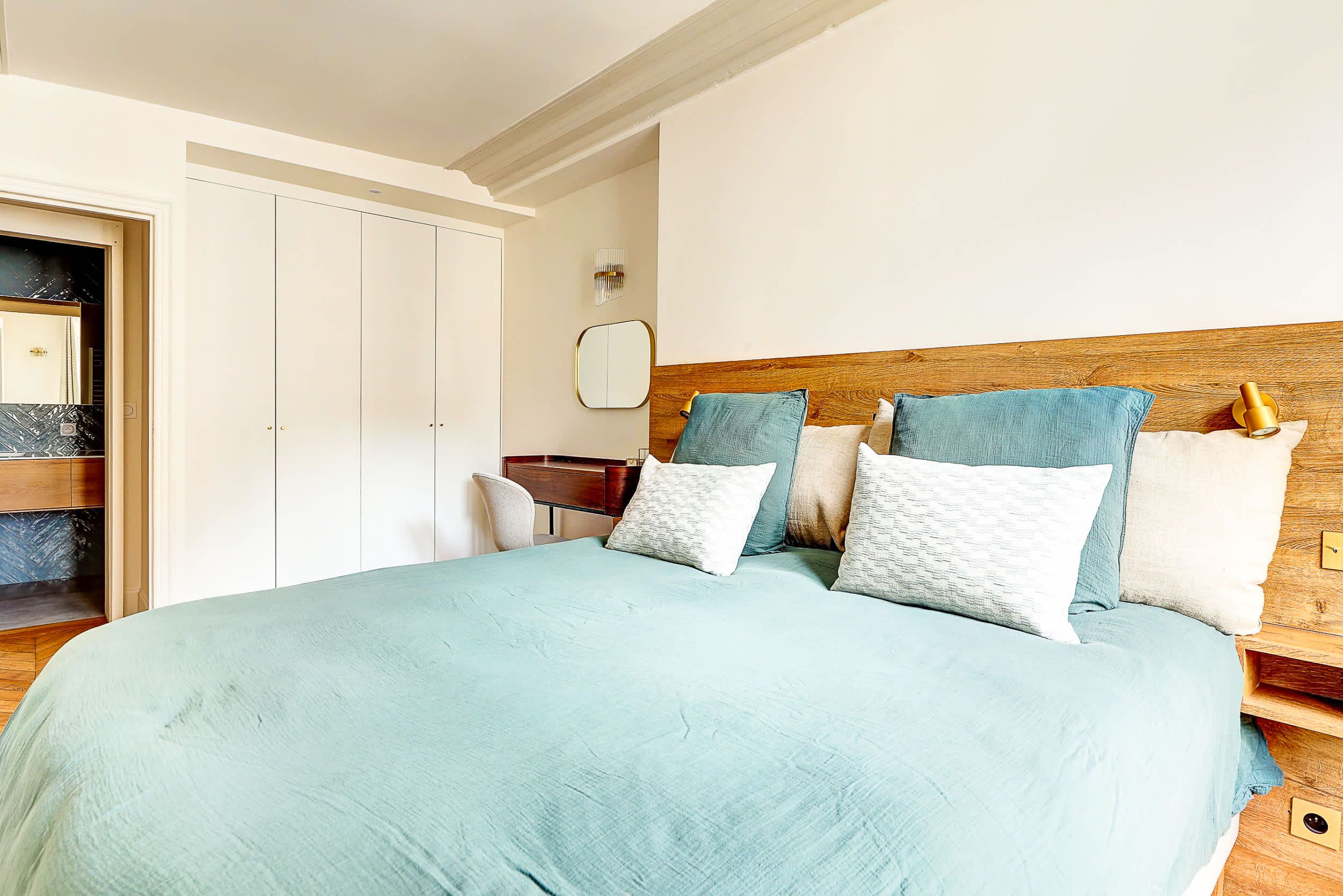 Bedroom 2: Comfortable double bed and a dedicated workspace with a desk.
