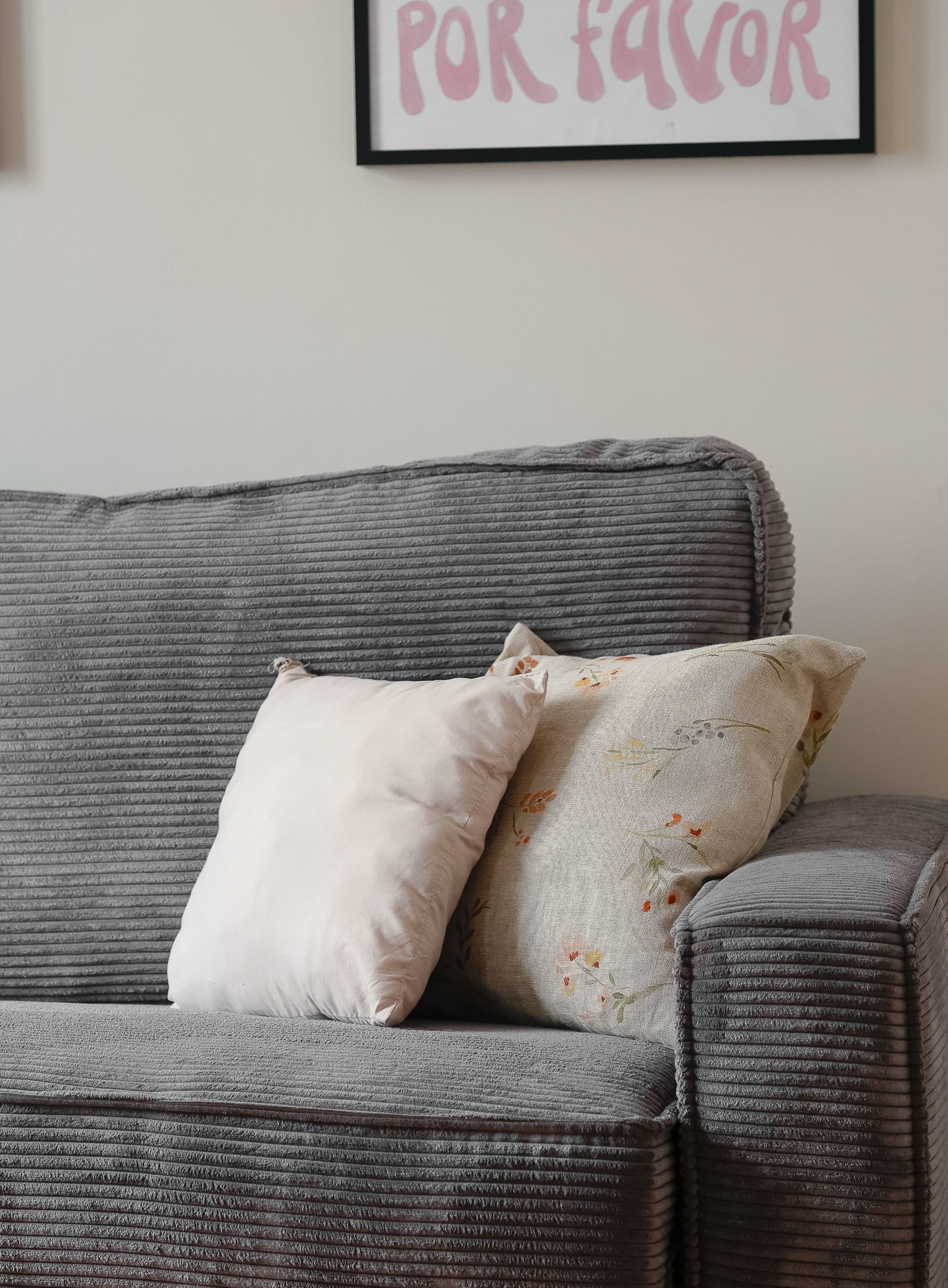 Modern Montparnasse apartment living room with convertible sofa, dining corner, and bright natural light.