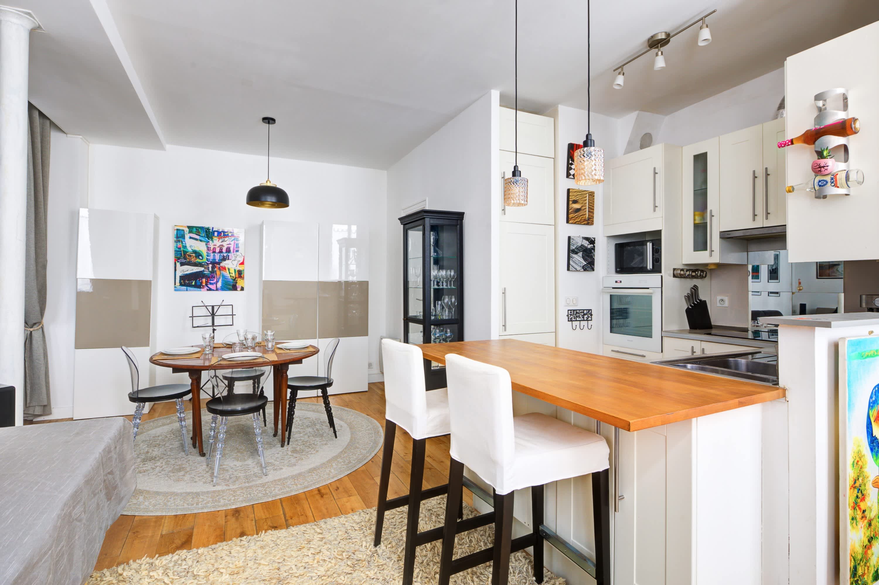 Functional fully equipped kitchen with a bar and two high stools