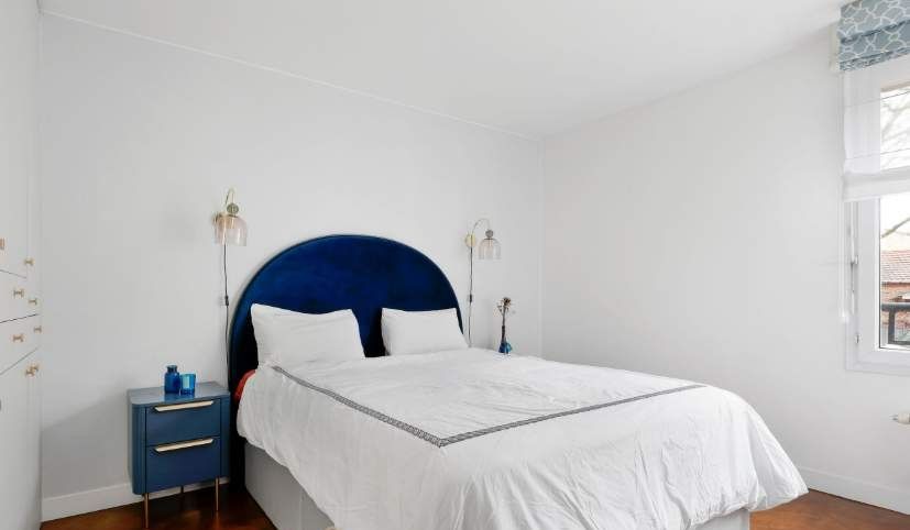 A bright and inviting bedroom featuring two comfortable single beds.