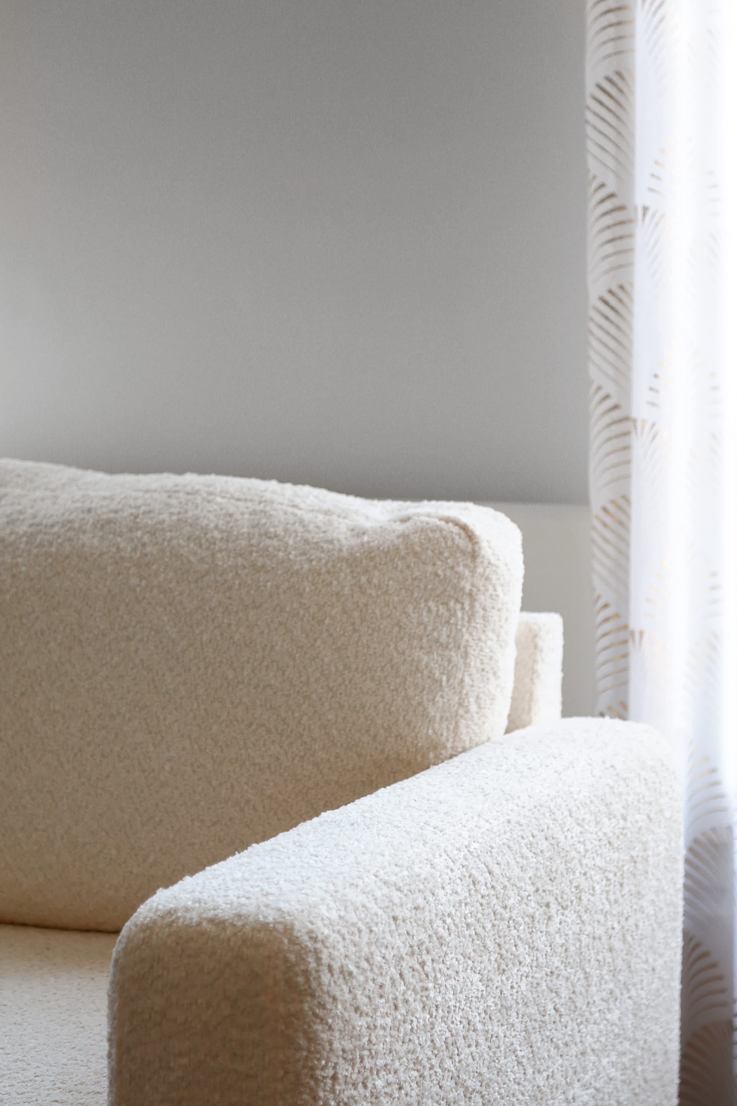 Top-floor Haussmann apartment on rue Meslay near République Paris 3rd, bright dual-aspect living room with designer sofa bed and refined decor