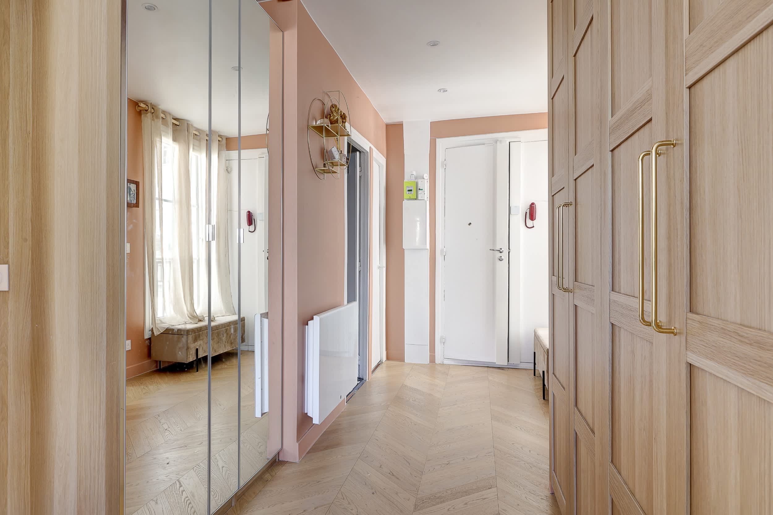 Top-floor Haussmann apartment on rue Meslay near République Paris 3rd, bright dual-aspect living room with designer sofa bed and refined decor