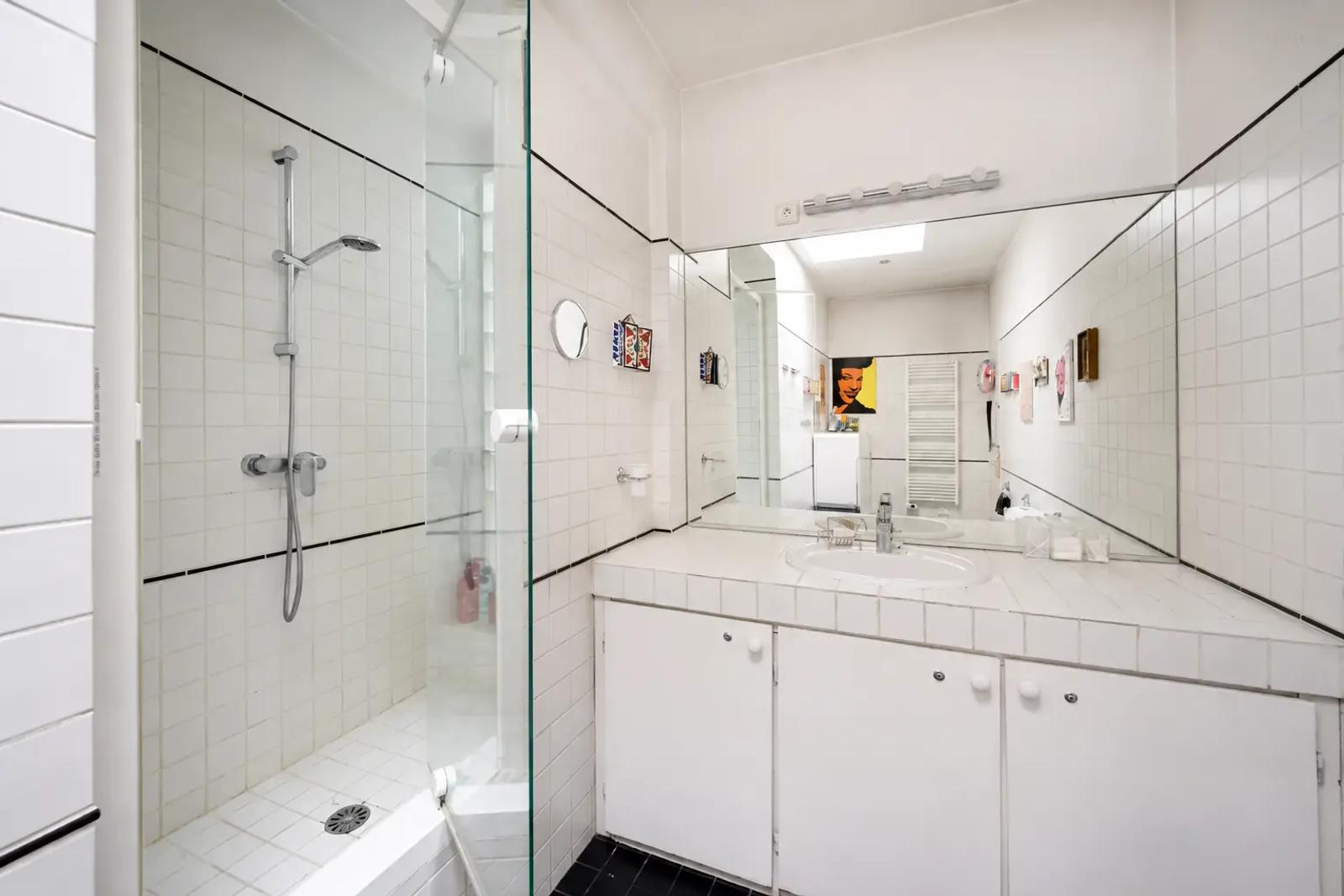 White tiled shower room with large mirror