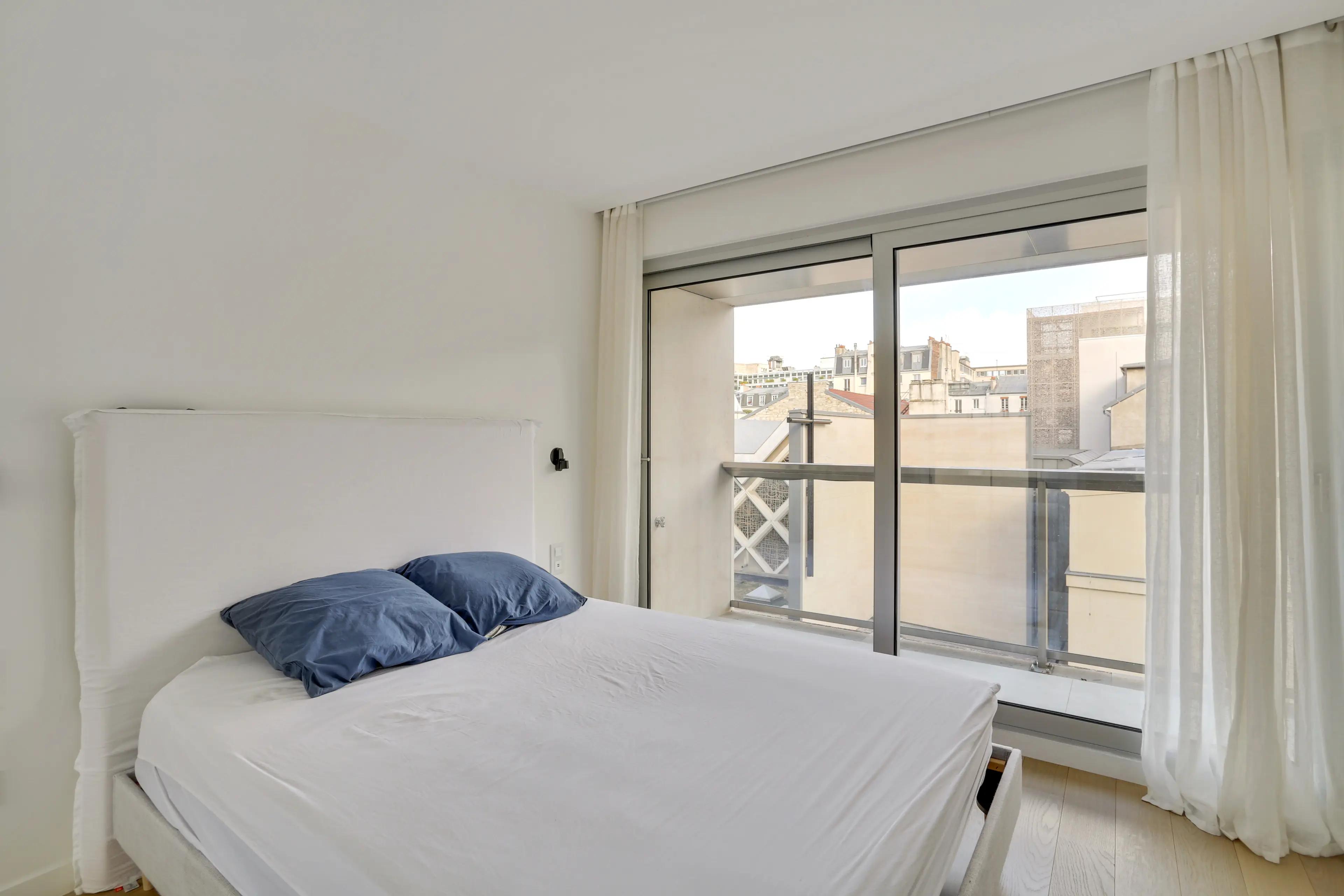 Renovated 4-bedroom duplex apartment for rent in Paris 7th arrondissement, bright living room with wraparound balcony and Paris rooftop view