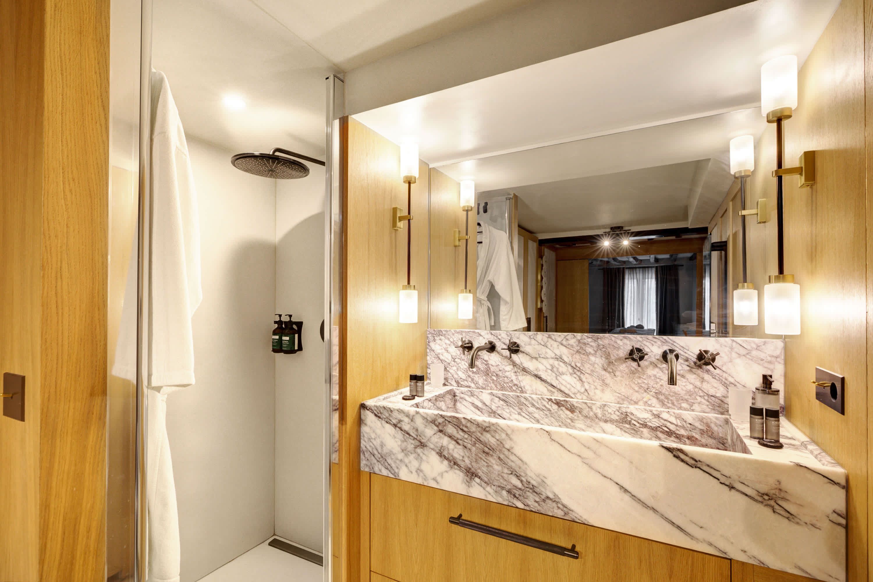 A modern, minimalist bathroom, fully equipped to provide comfort and relaxation throughout your stay.