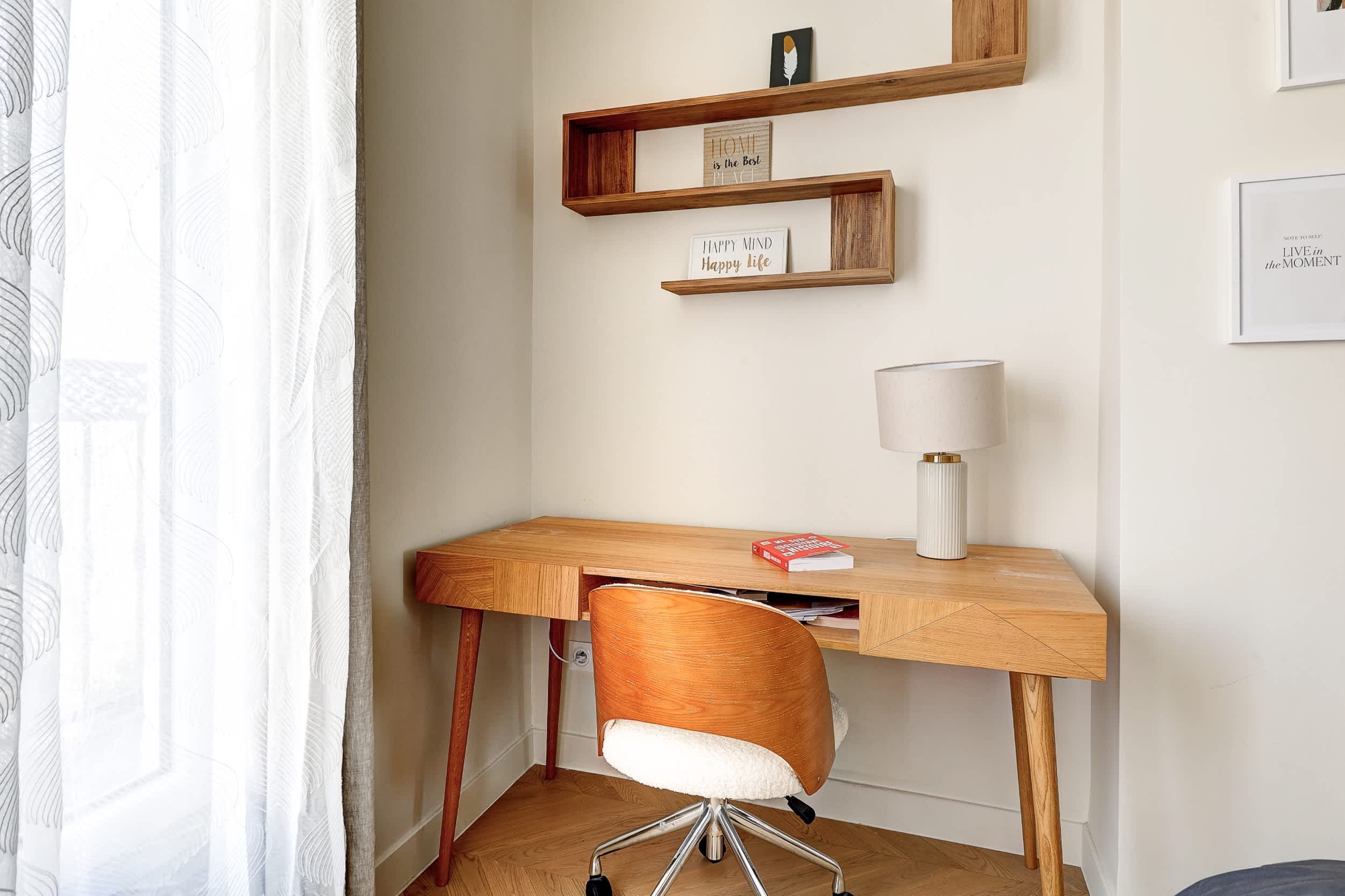 Top-floor Haussmann apartment on rue Meslay near République Paris 3rd, bright dual-aspect living room with designer sofa bed and refined decor