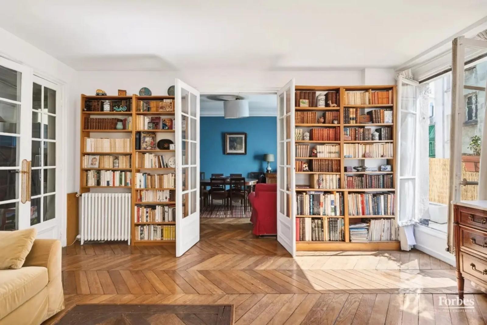 Grand salon avec parquet et bibliothèques