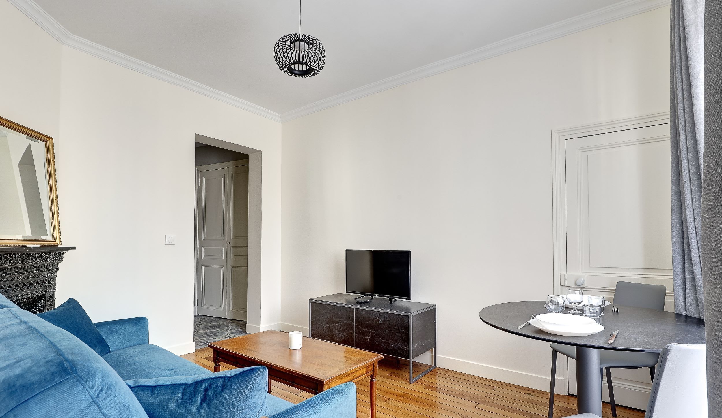 Welcome to our elegant living area, where you'll find a comfortable sofa, a TV, and a dining space for relaxing and enjoying your meals.