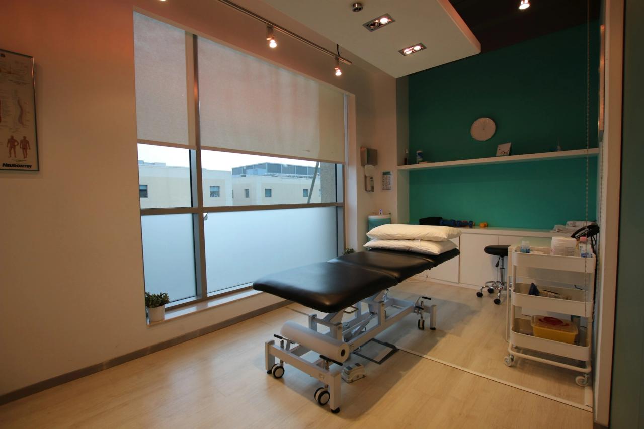 An empty treatment table in a physiotherapy clinic room.