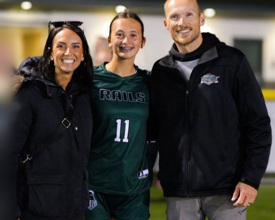 Emily Holter with her husband and daughter at a soccer game