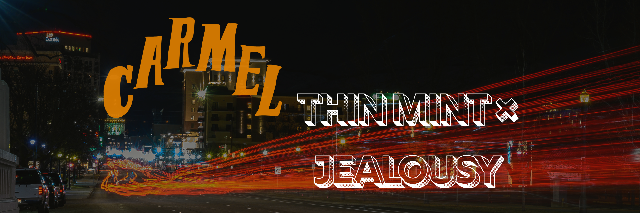 Nighttime city street scene with streaks of red and orange light trails from moving vehicles. Buildings line both sides of the street, illuminated with various lights, including the US Bank building in the background. The text “Carmel Thin Mint × Jealousy” overlays the image in bold, stylized fonts—“Carmel” in large orange letters and “Thin Mint × Jealousy” in white with a patterned fill.