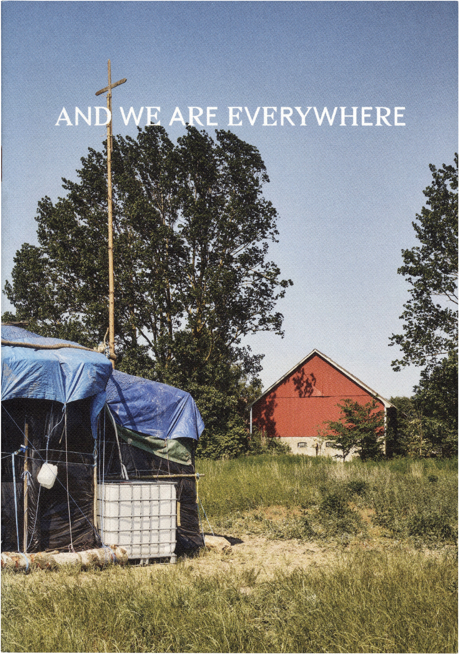 Makeshift structures covered in blue tarps, with a tall cross on a pole in a grassy field. A red barn stands in the background. Text reads: 'AND WE ARE EVERYWHERE'.