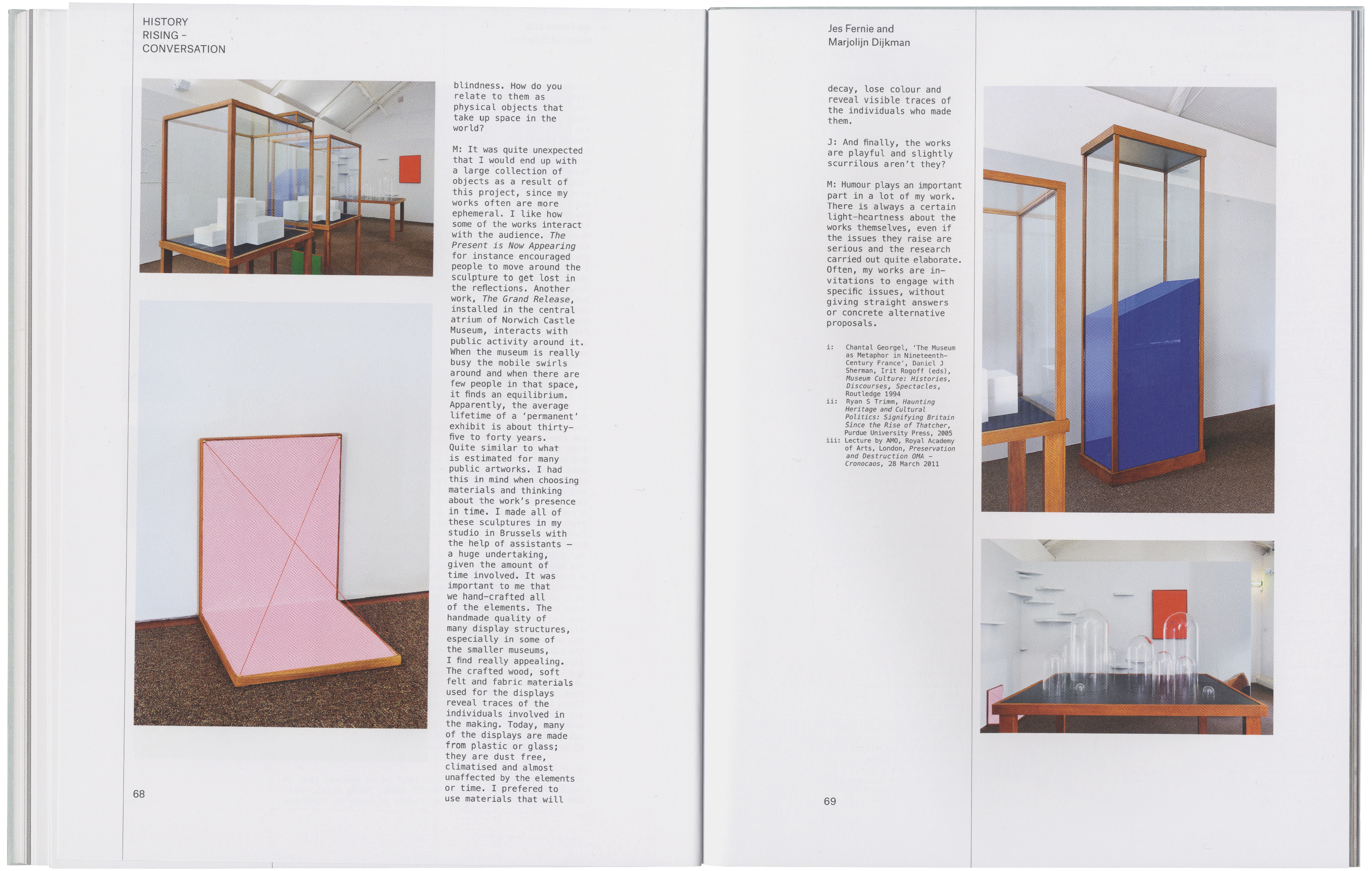 Two open book pages displaying photographs of various art installations, including display cases, sculptures, and accompanying text.