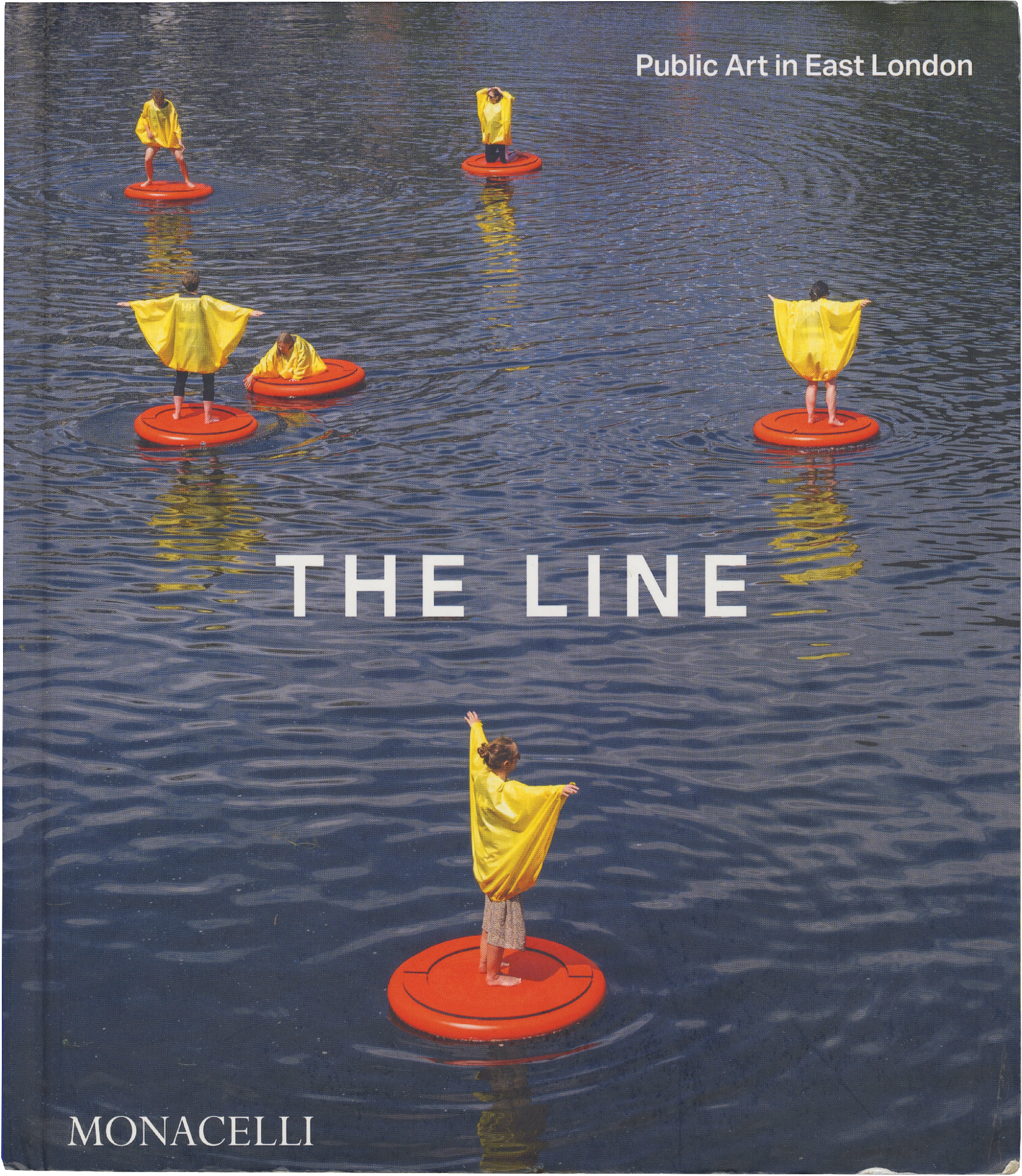 Book cover: Several figures in yellow ponchos stand on orange floating rafts in blue water. White text reads "THE LINE," with "Public Art in East London" at the top right and "MONACELLI" at the bottom left.