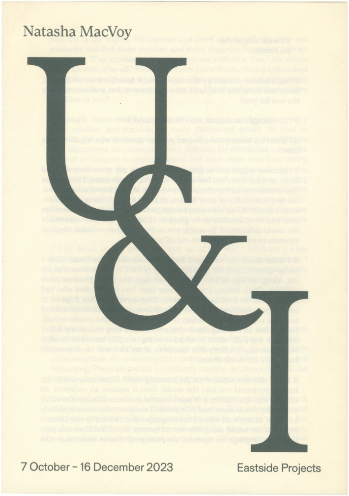 Exhibition poster for Natasha MacVoy: U & I, at Eastside Projects from October 7 to December 16, 2023. Features large, dark grey serif letters "U", "&", and "I" over faded background text.
