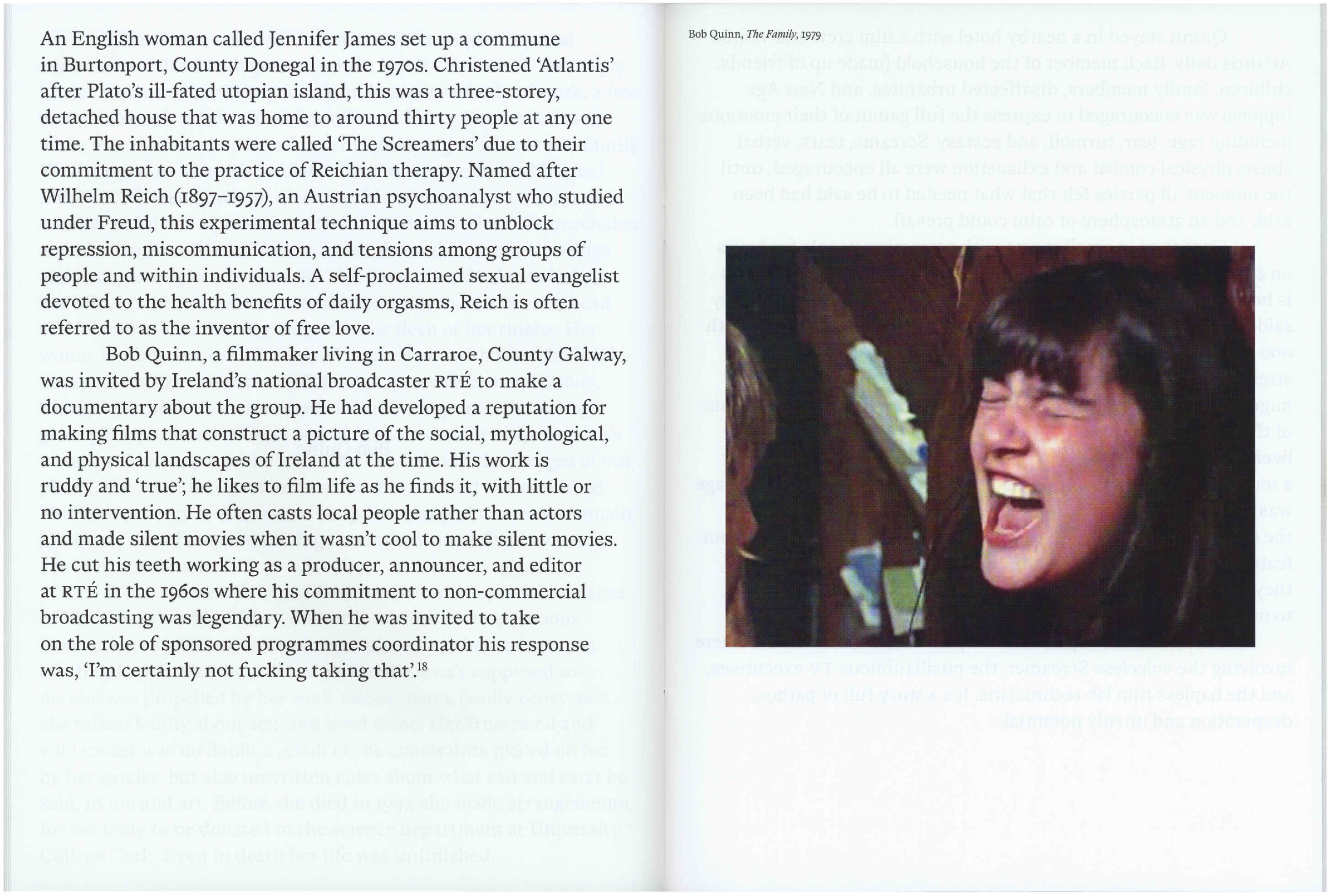 A woman with dark hair and bangs, eyes squeezed shut, shouts or screams with her mouth wide open.