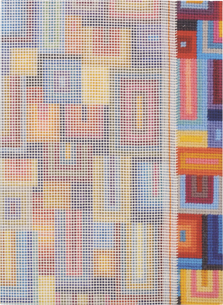 A needlepoint canvas with an abstract colorful geometric pattern, partially stitched on the right side.
