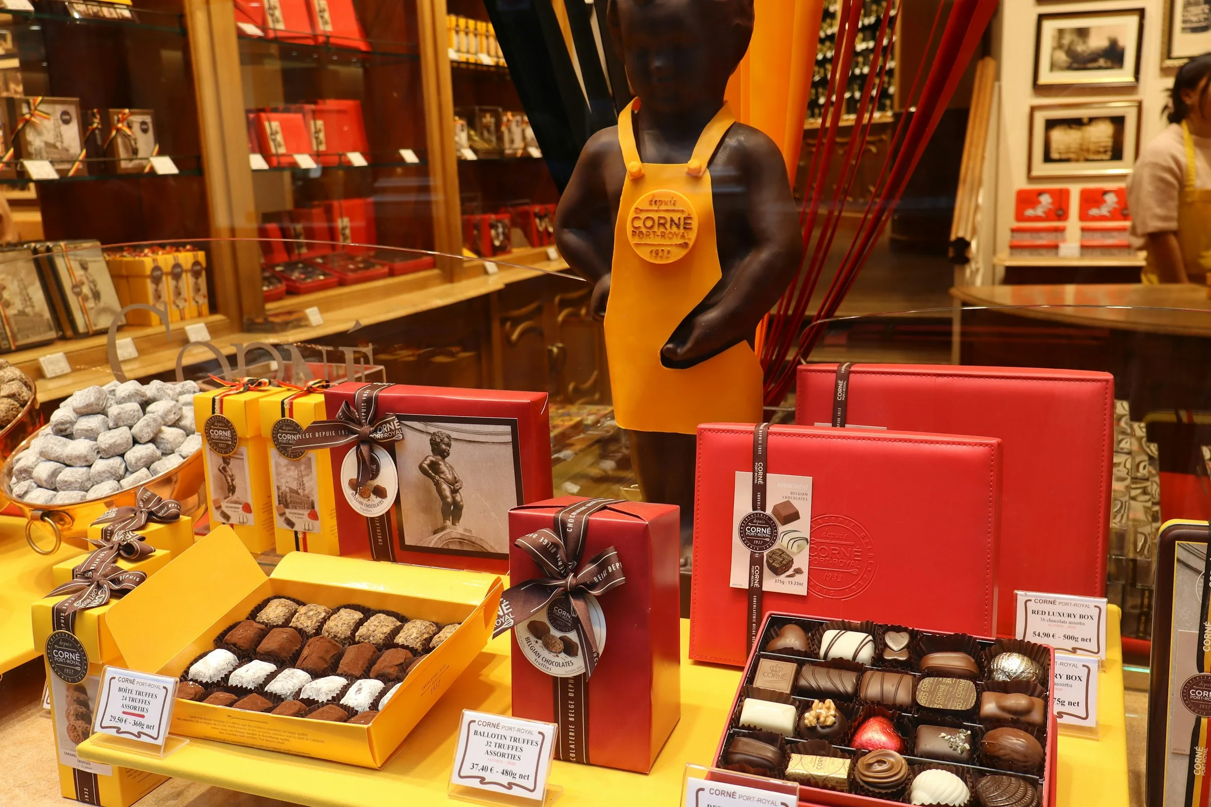 Cokelat Belgia berbagai bentuk tertata di rak toko cokelat di Brussels.