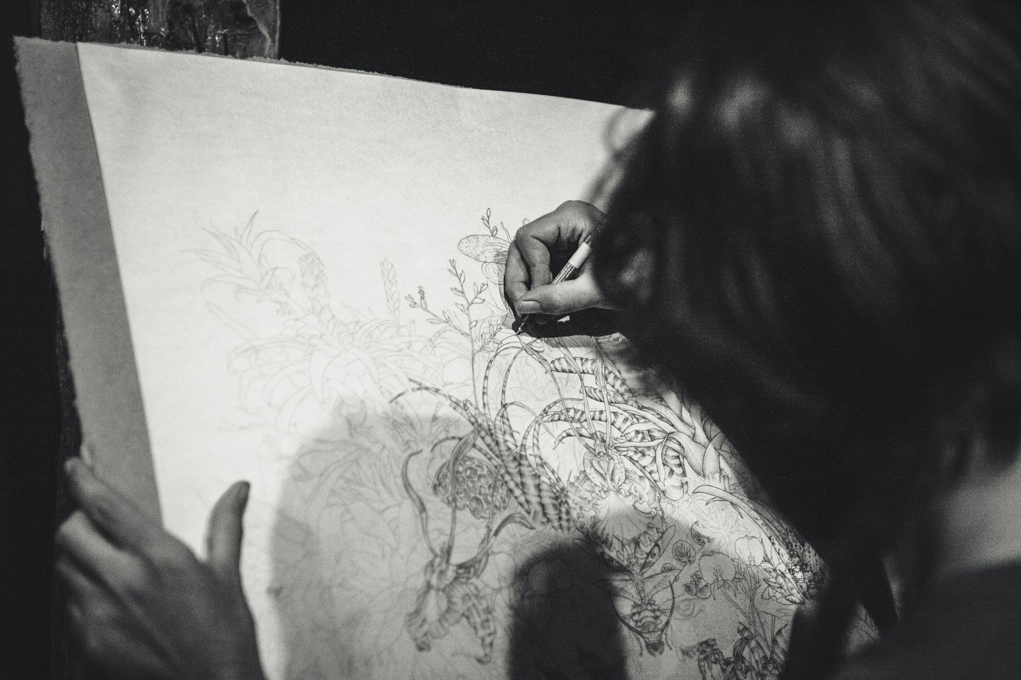 Woman drawing flowers - a grayscale photo.