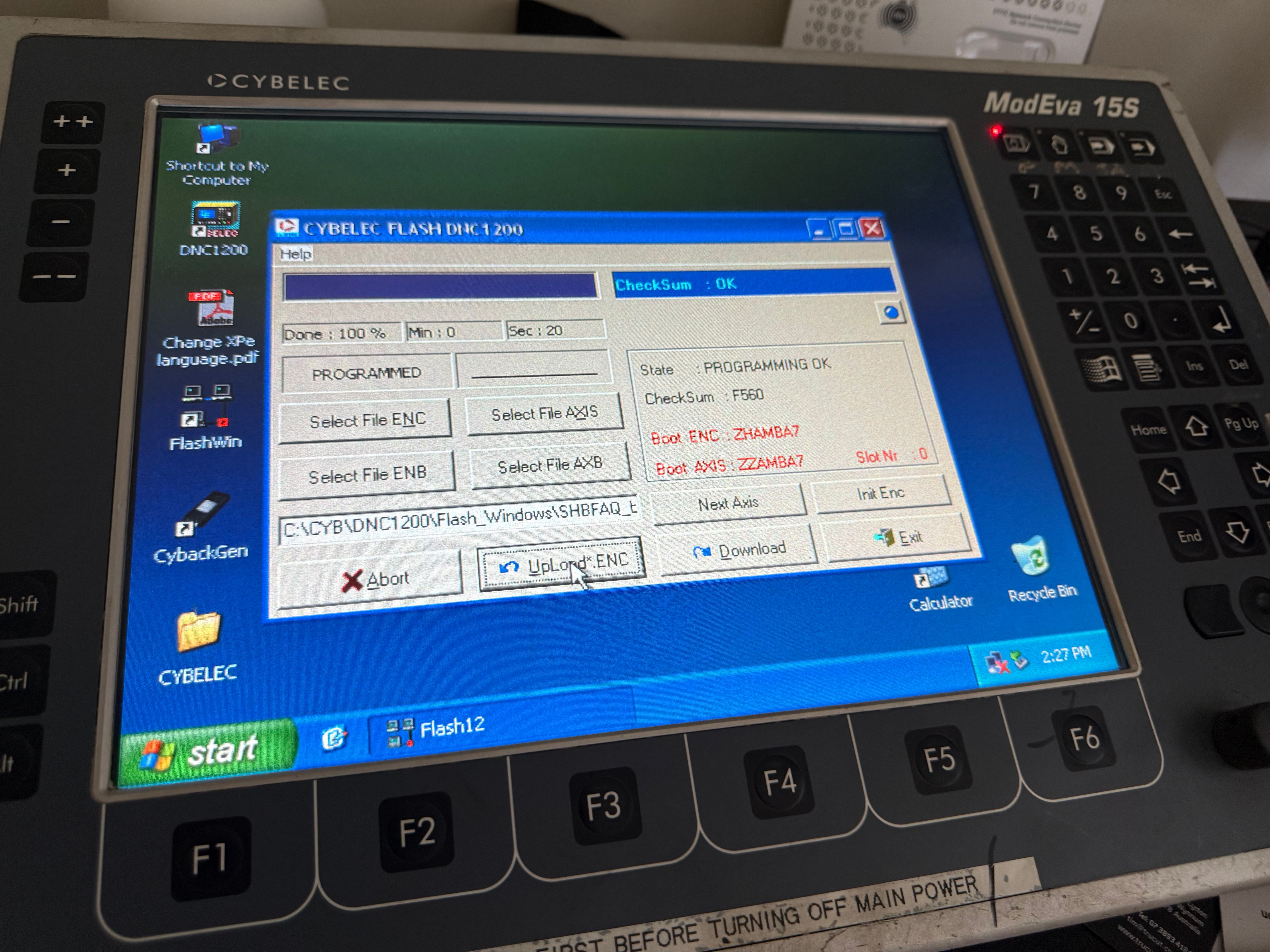 Close-up of a Cybelec ModEva 15S control screen showing the DNC1200 flash utility reporting programming OK.
