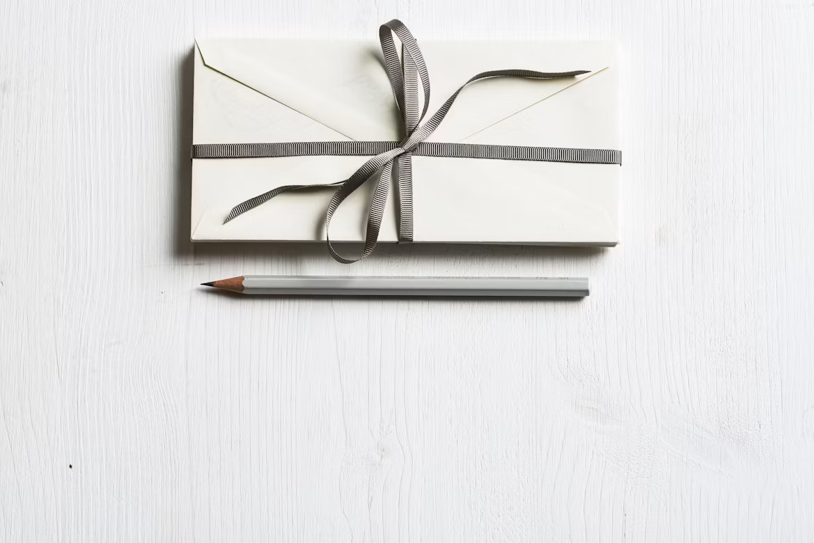 A simple gift envelope with a pencil on a white table