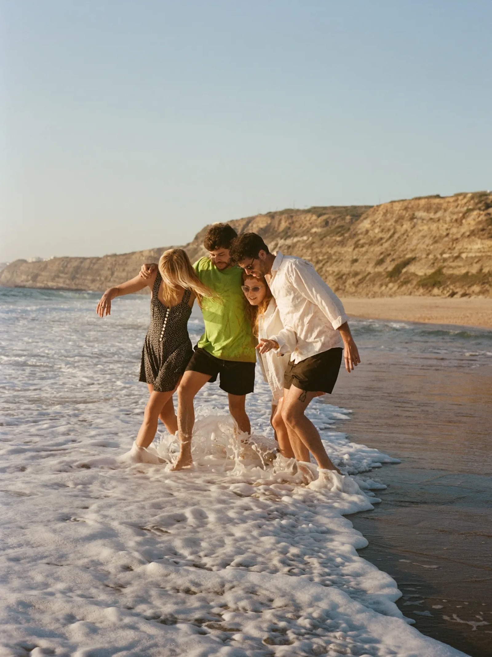Group of friends standing together at the beach