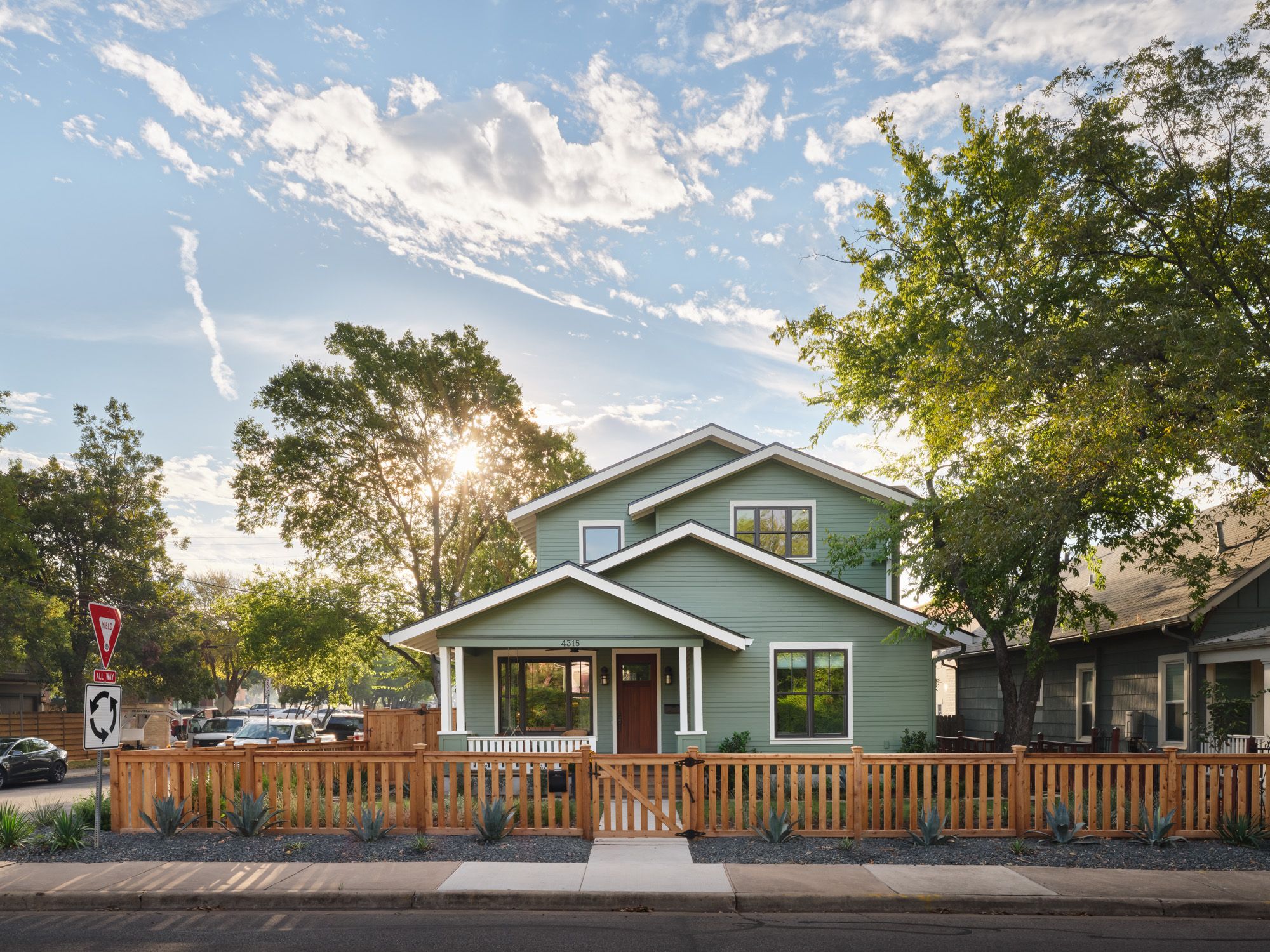 Two-story house with front porch and fenced yard