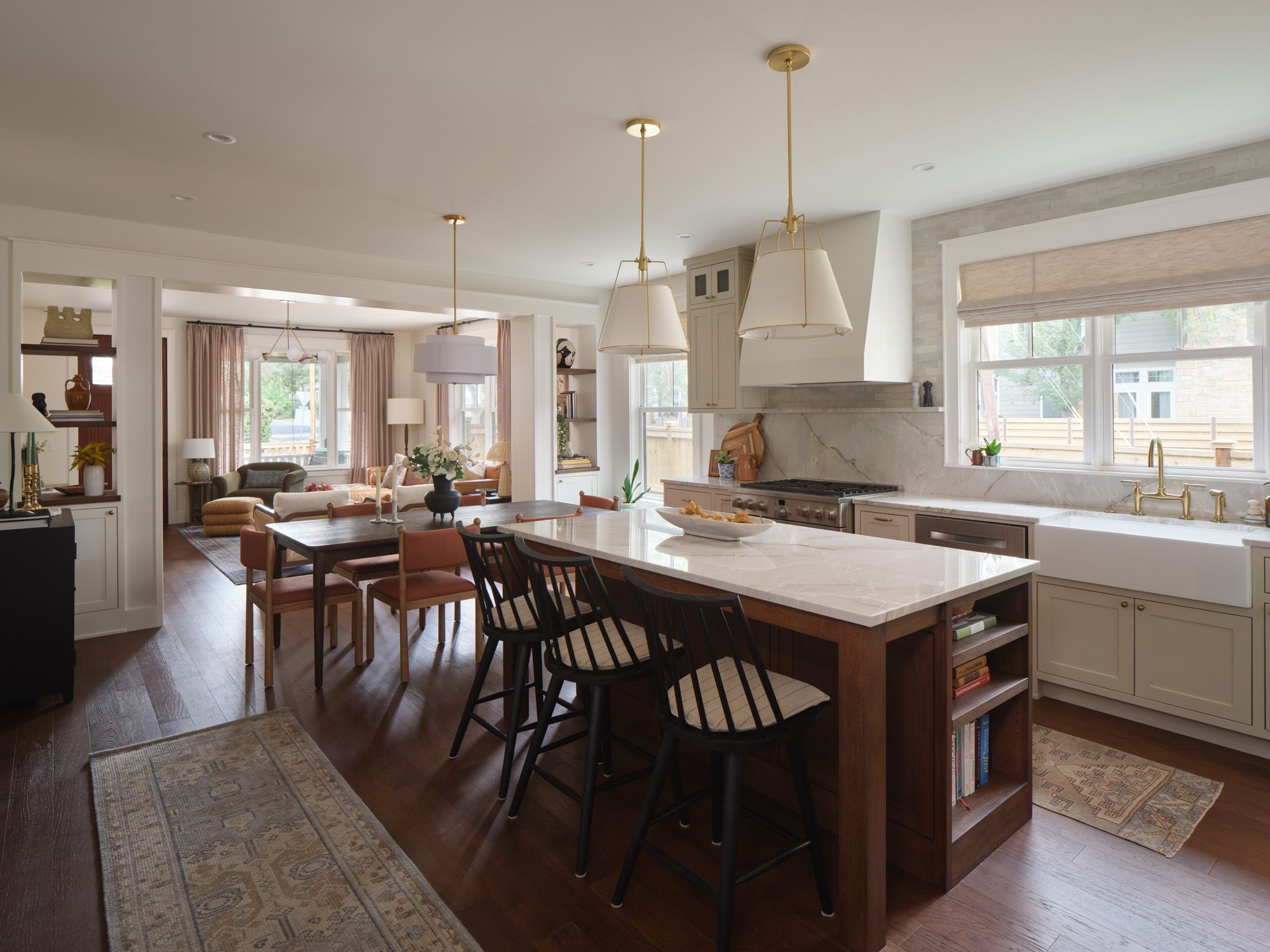 Open-plan kitchen with island seating, dining table and adjoining living room