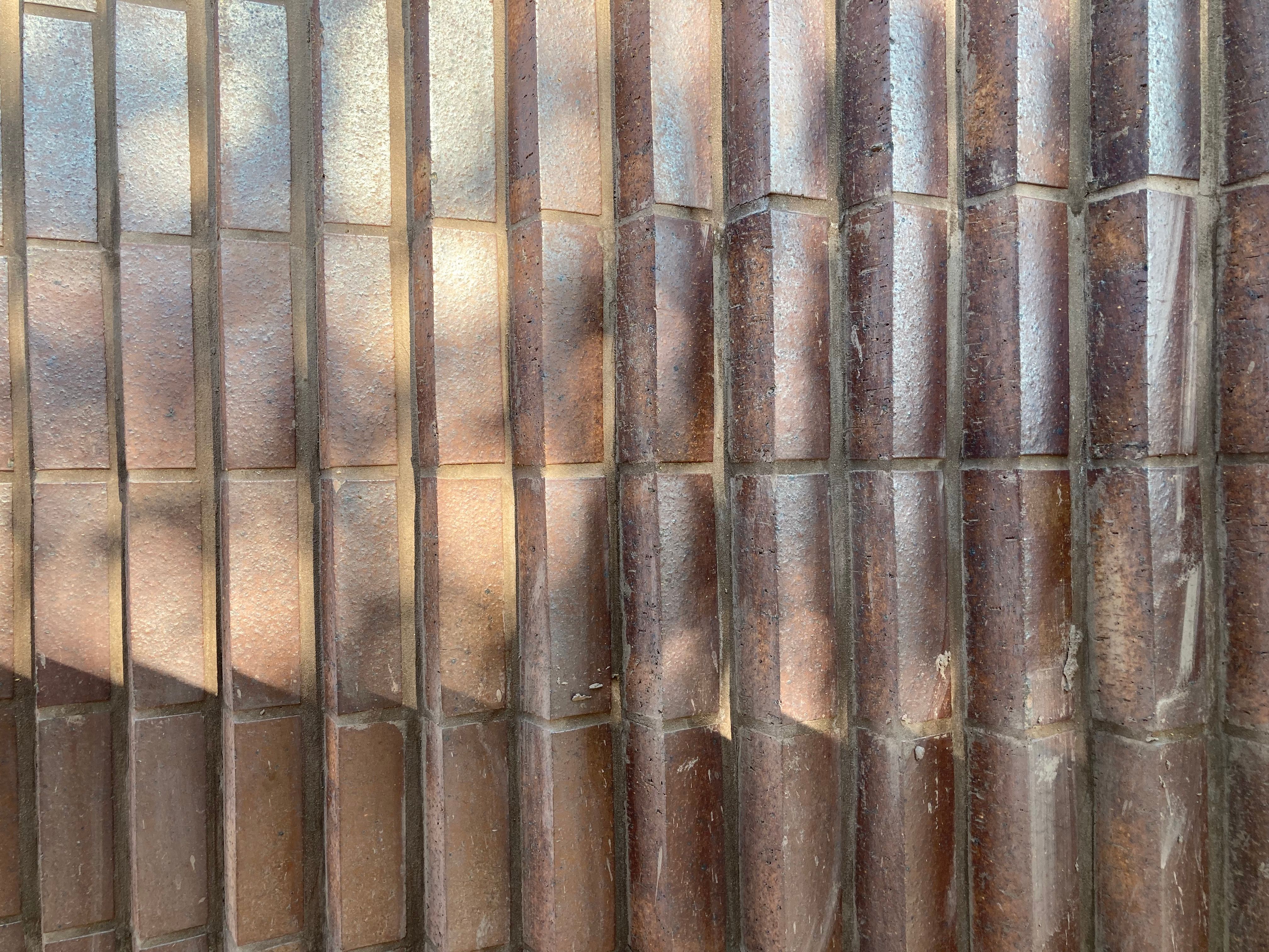 Close-up of a textured wall with repeating vertical ridges