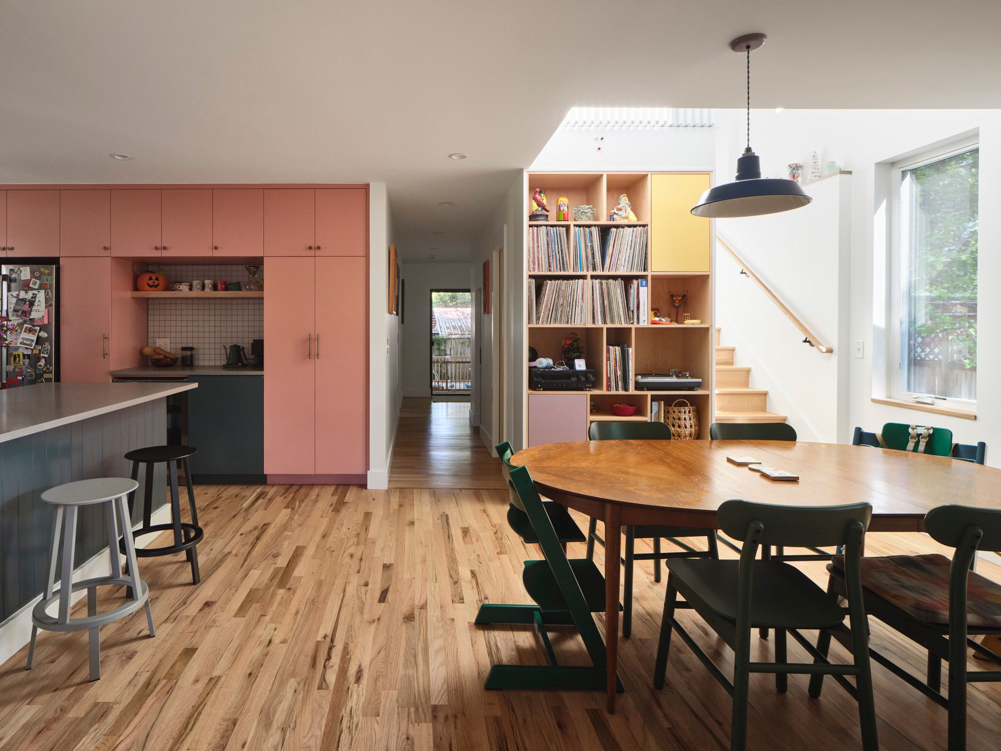 Open-plan kitchen and dining area with built-in record shelving