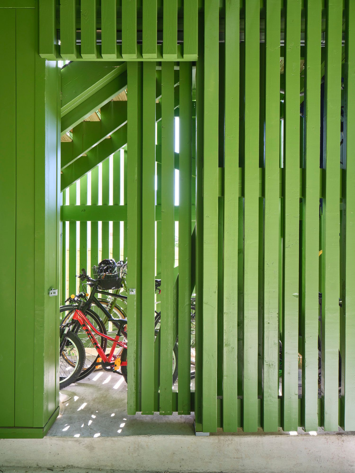 Bicycles parked behind vertical wooden slats