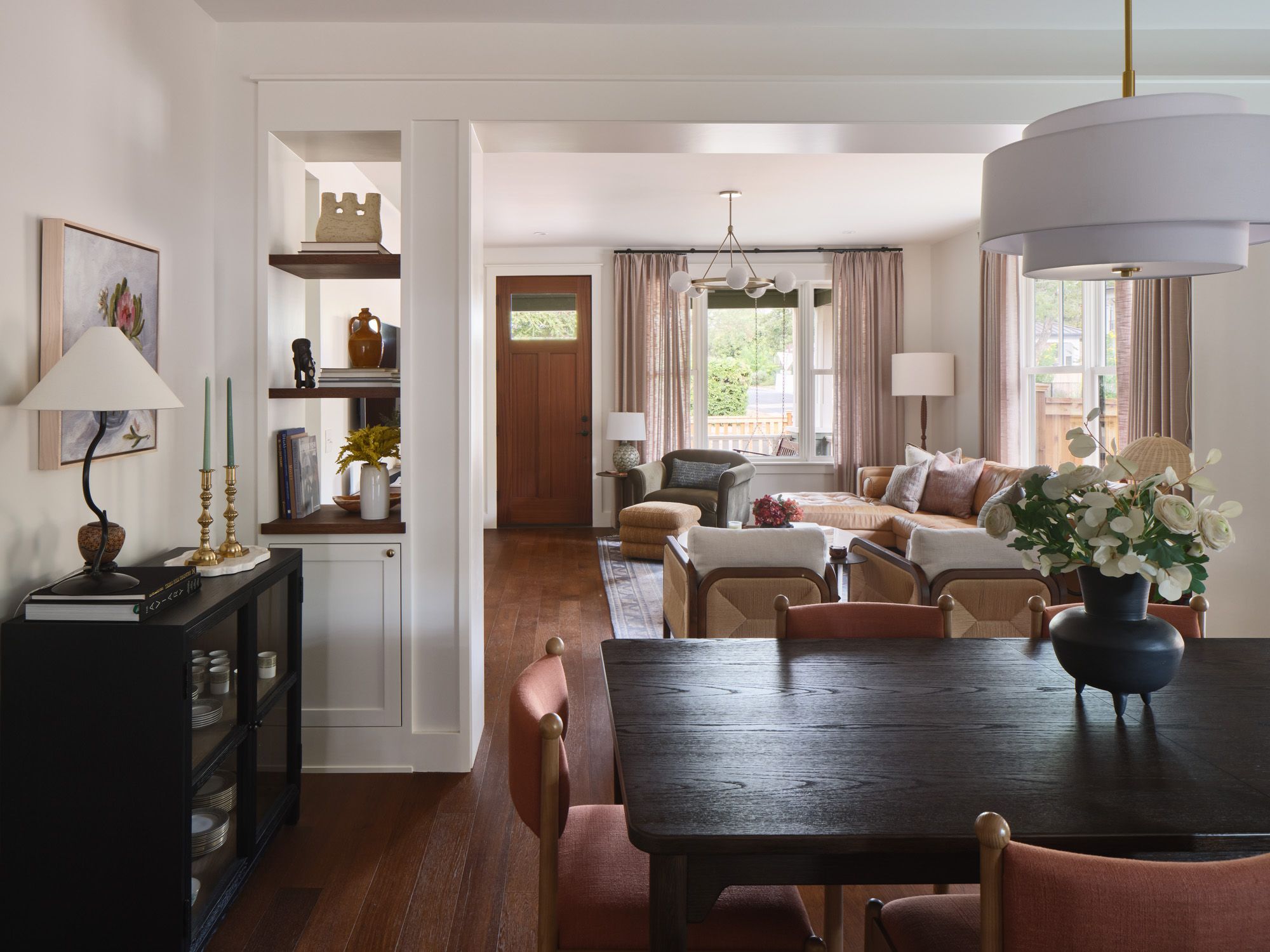 Dining room opens into a living room with built-in shelving