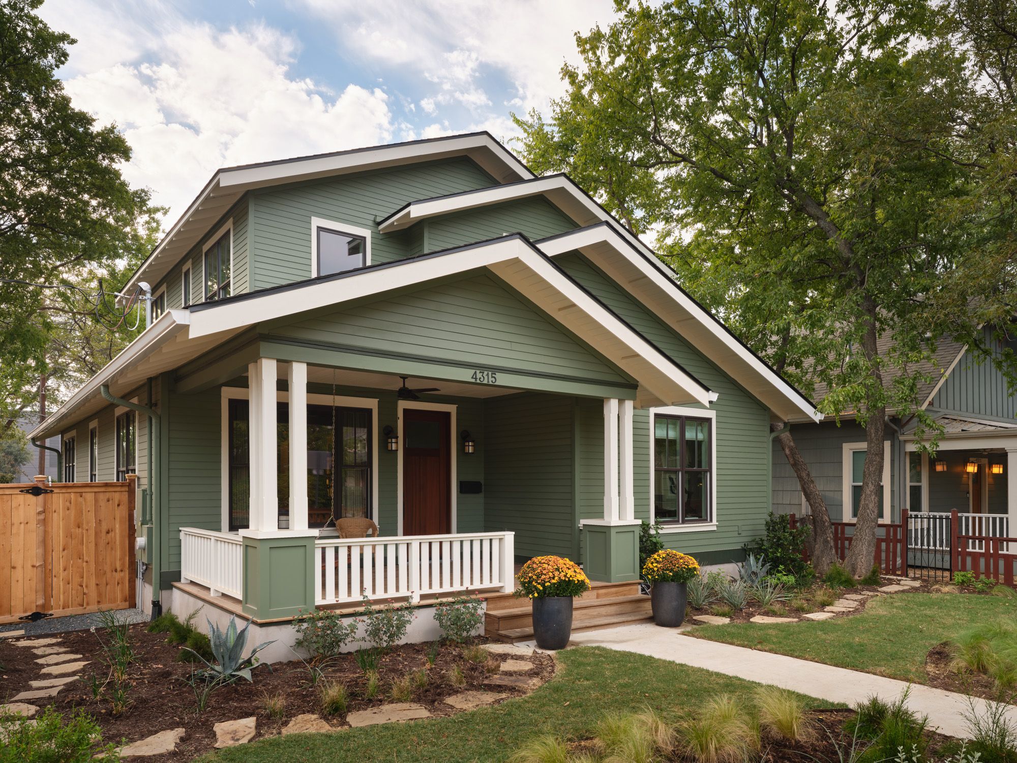 Two-story house with covered front porch and landscaped yard