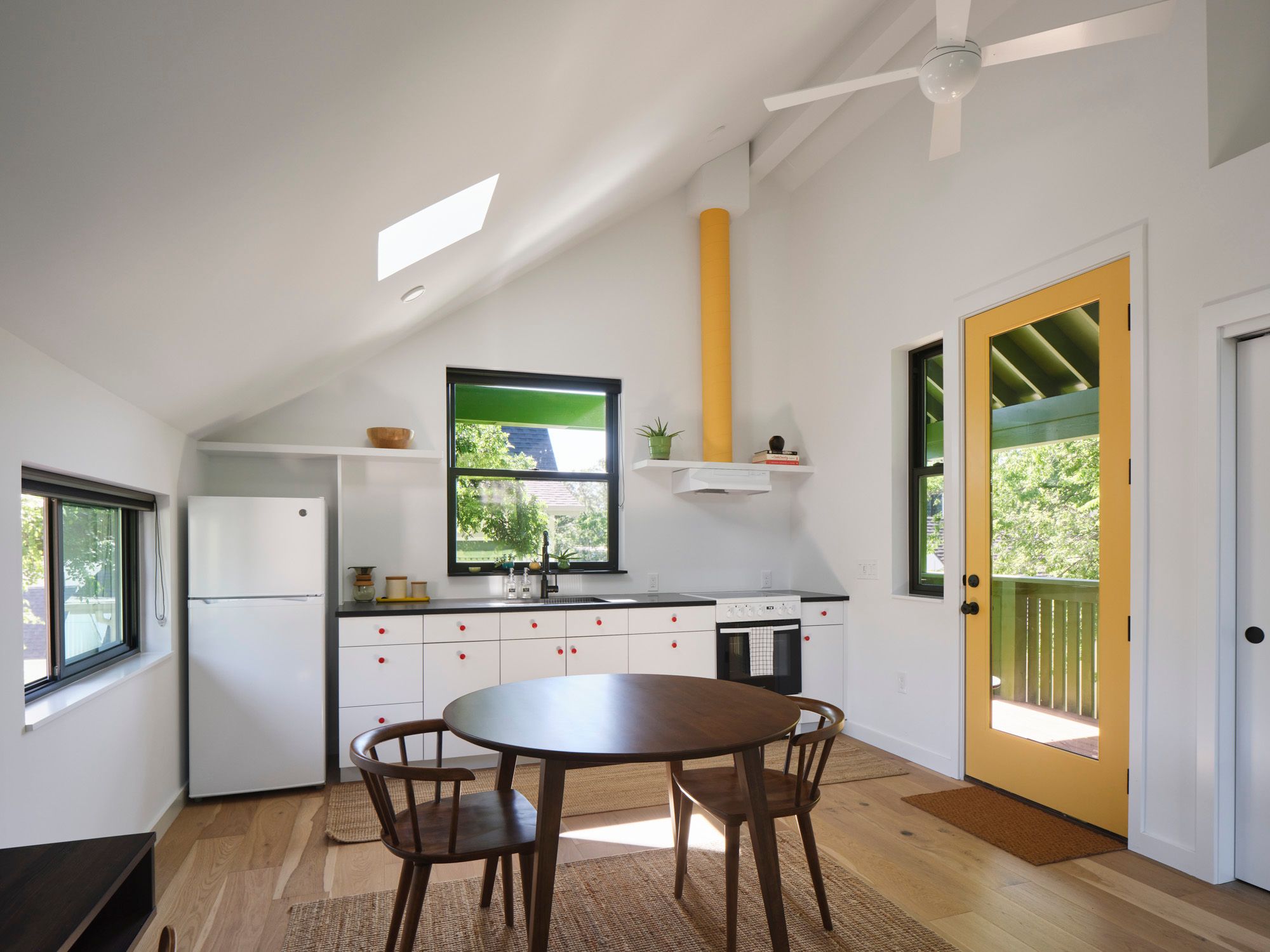 Kitchen and dining area with round table and glass patio door