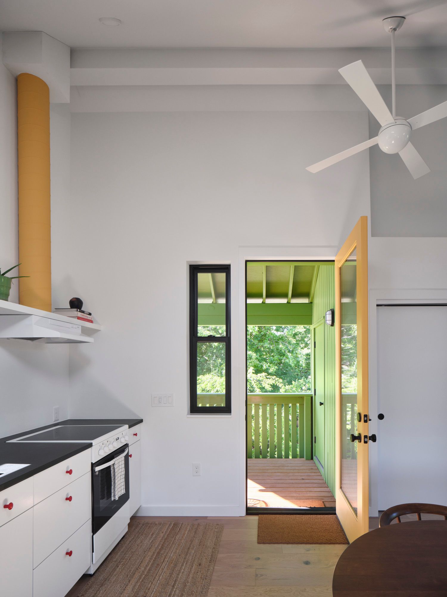 Kitchen with open door leading to a covered porch