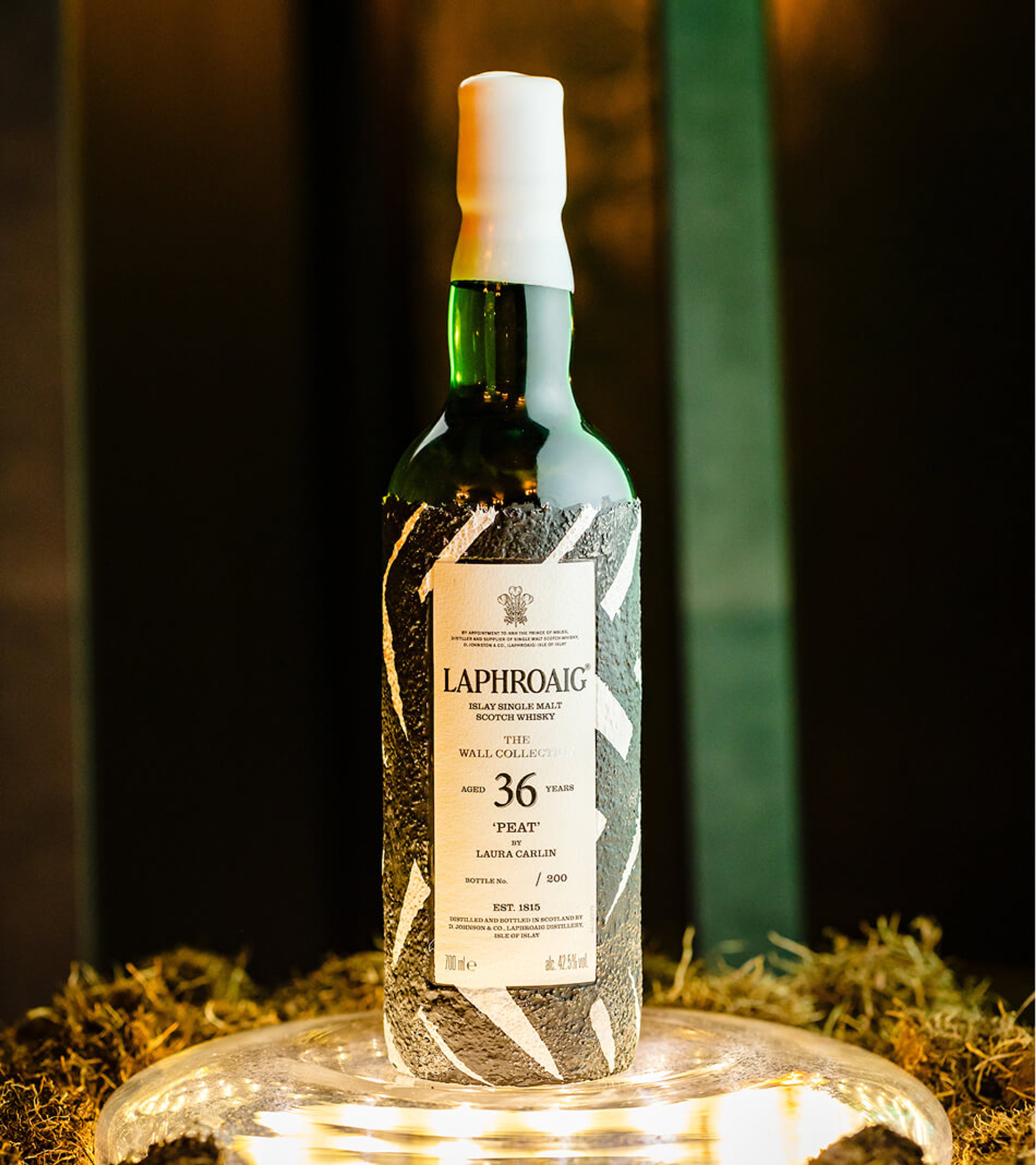 A bottle of Laphroaig 36-Year-Old 'Peat' Islay Single Malt Scotch Whisky with a textured wrapper