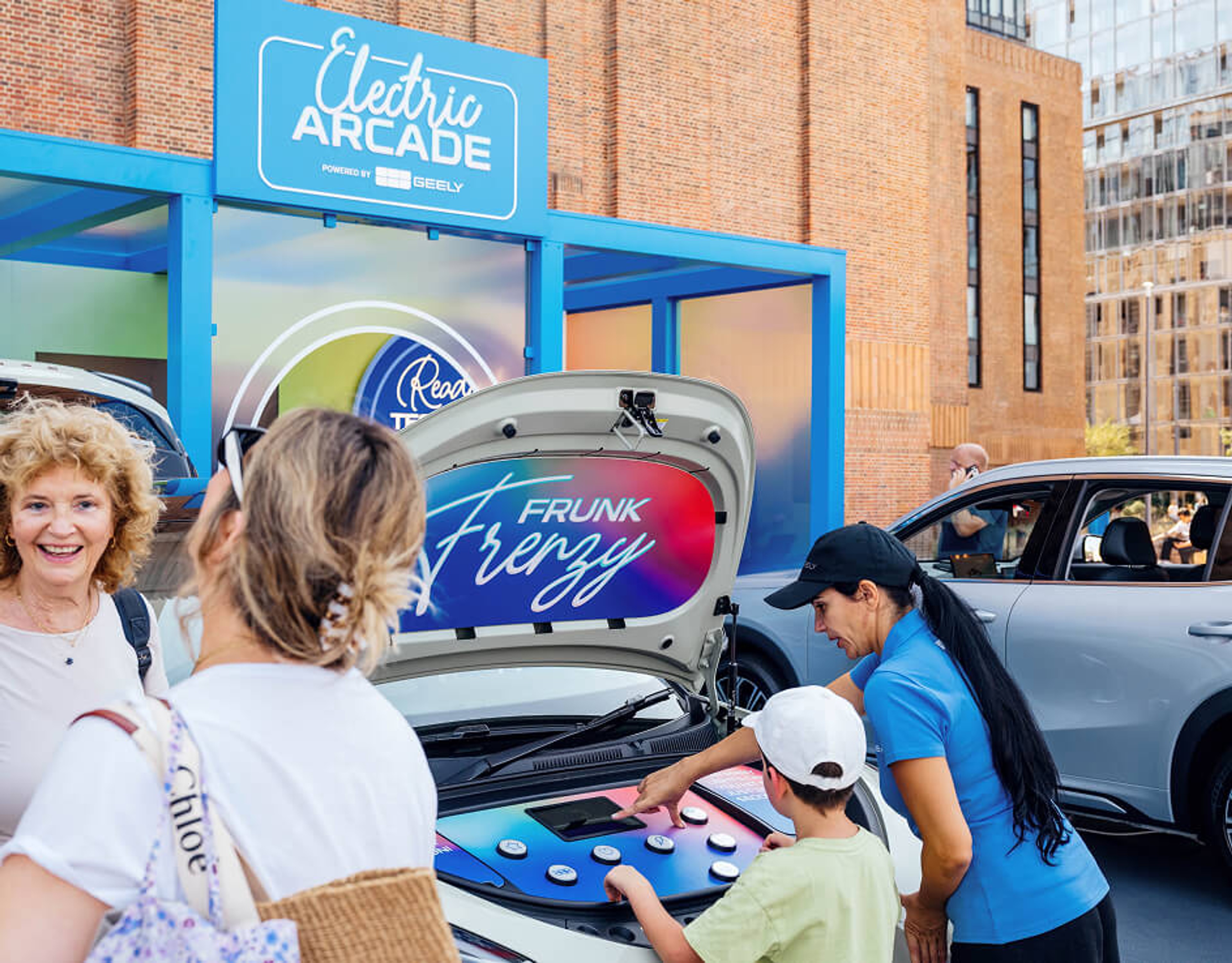 A child playing an interactive Frunk Frenzy game inside the front trunk of an electric car outside Battersea Power Station