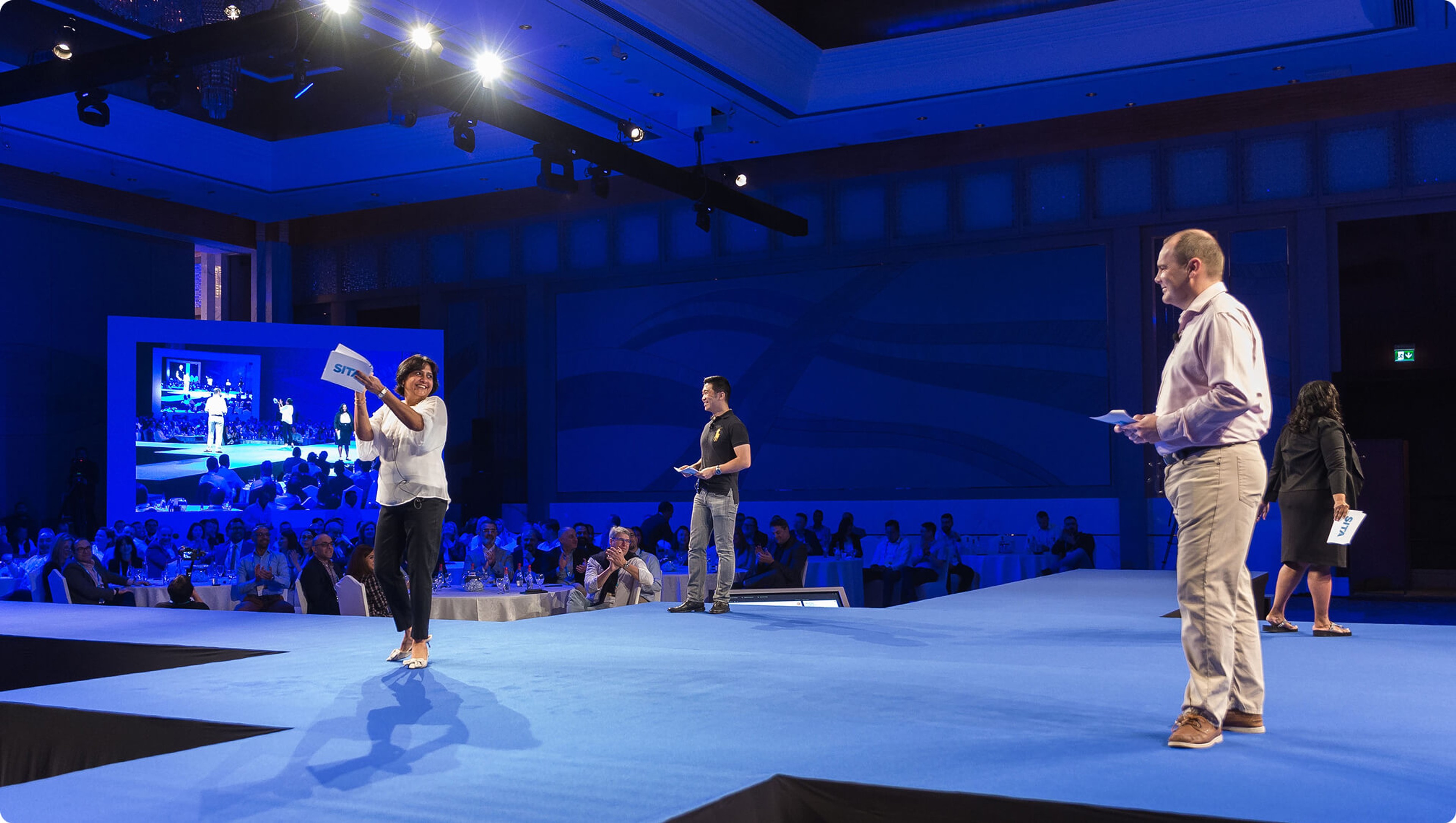 Conference team on stage presenting