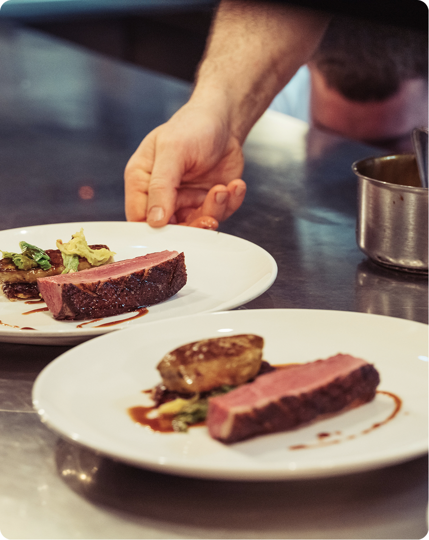 Chef plating a fine dining dish for guests at the BT Security Advisory Board event