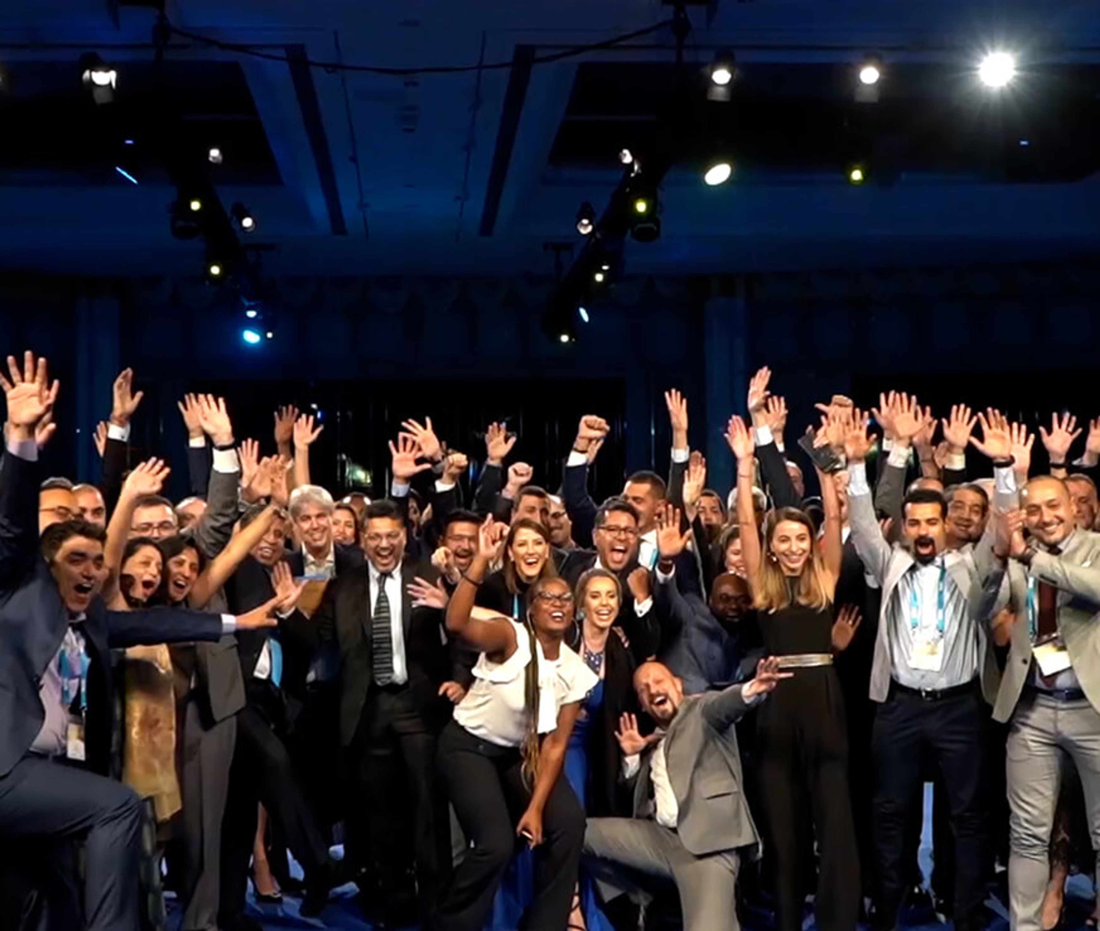SITA attendees all huddled together with their arms in the air