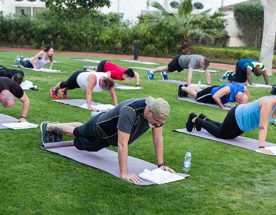 SITA attendees doing a yoga pose on grass