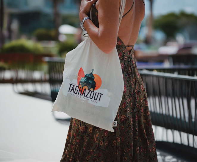 Guest carrying a branded ‘Taghazout Success Trip 2024’ tote bag.