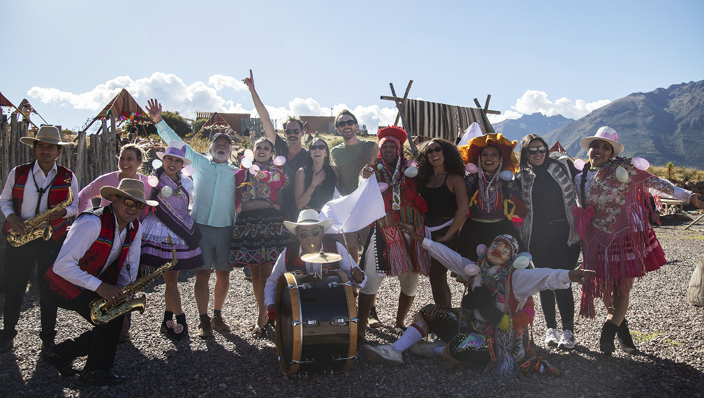 Incentive travel group in Peru taking group picture with Locals at a traditional camp