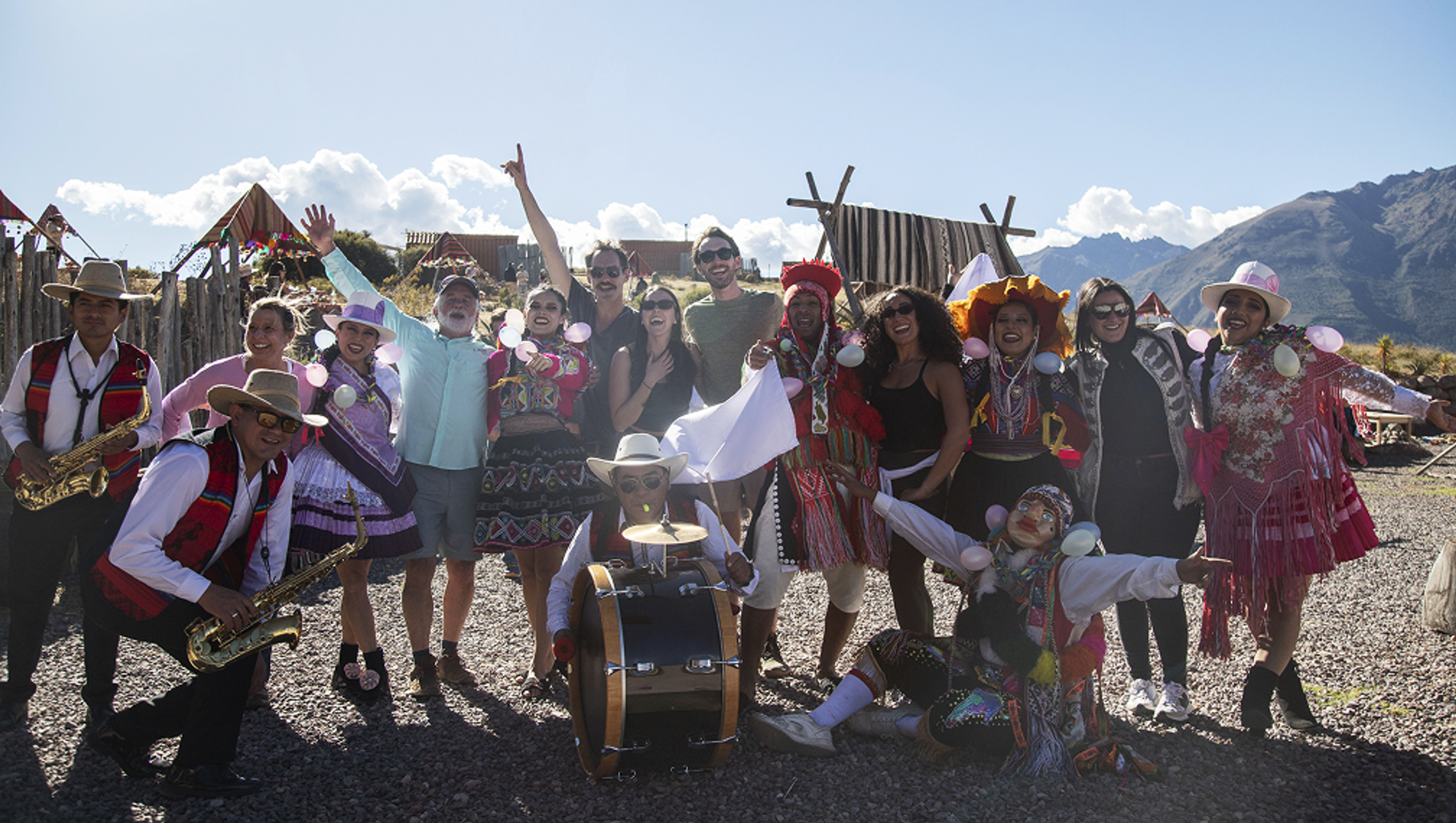 Incentive travel group in Peru taking group picture with Locals at a traditional camp