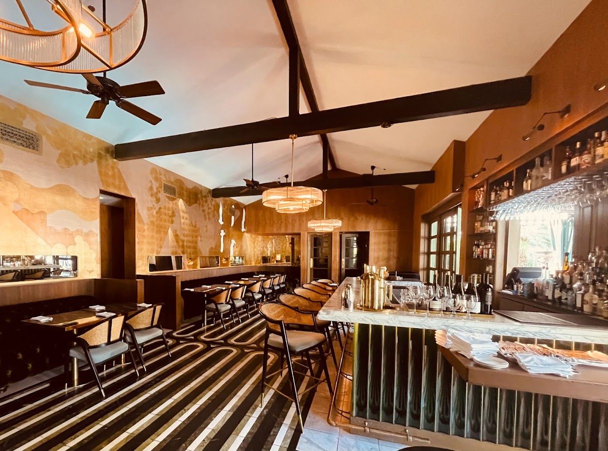 hotel bar with high bar stools around a marble counter 