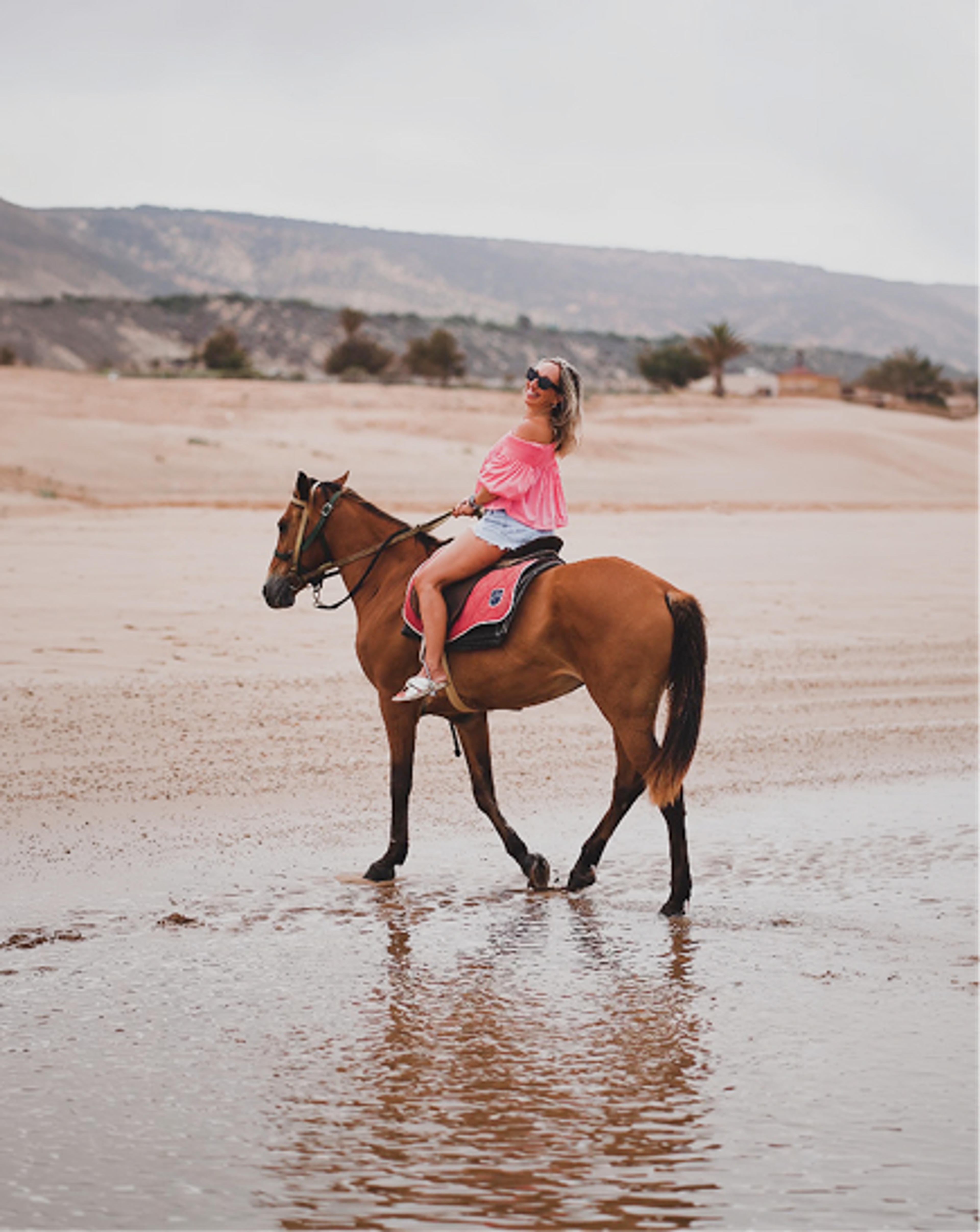 Nu Skin guest riding a horse along the beach in Morocco.